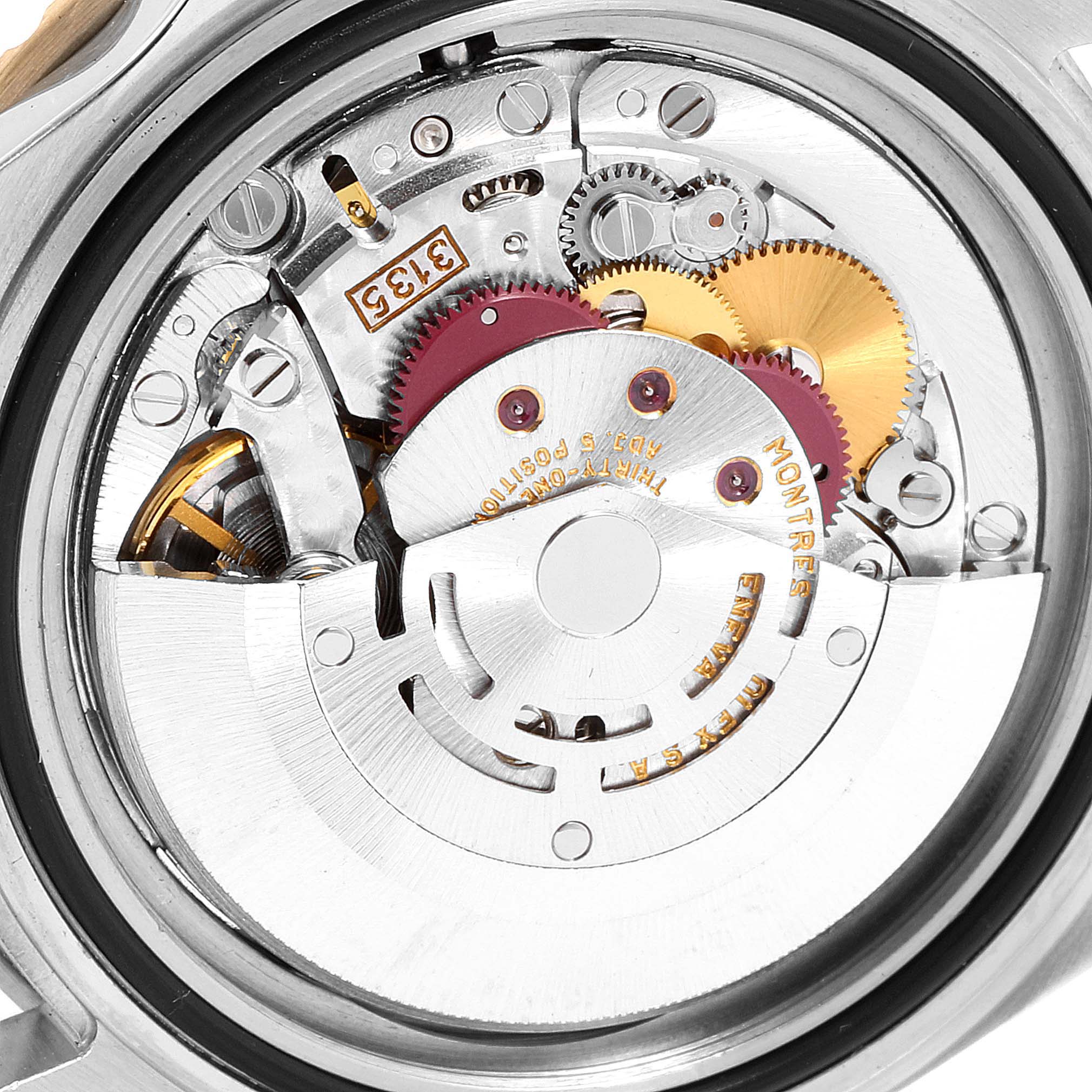 The image shows the inner mechanical movement of a Rolex Submariner 16613 Men
s Stainless Steel Blue Dial 16613 Men
s Stainless Steel Blue Dial watch viewed from the back.