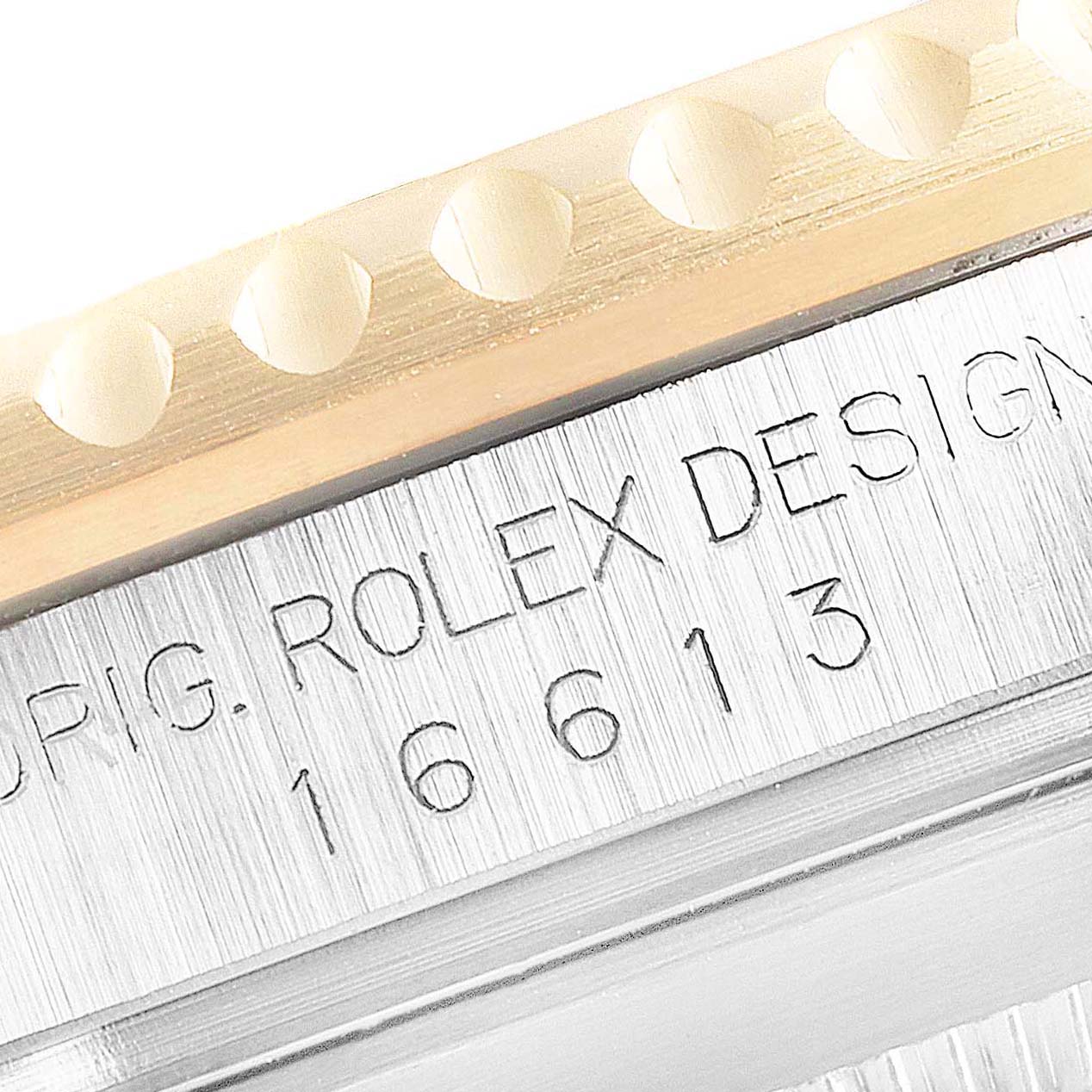 Close-up of the Rolex Submariner 16613 Men
s Stainless Steel Blue Dial 16613 Men
s Stainless Steel Blue Dial model showing part of the bezel and the engraved serial number on the side of the case.