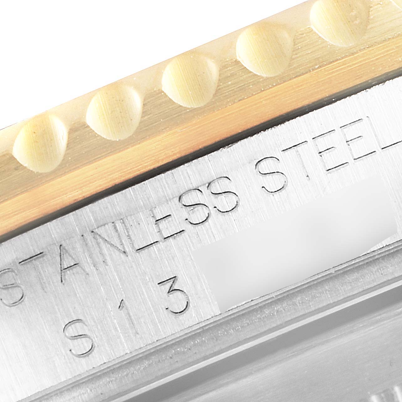 The image shows a close-up of the edge of the bezel and part of the case with engraved text of a Rolex Submariner 16613 Men
s Stainless Steel Blue Dial 16613 Men
s Stainless Steel Blue Dial watch.