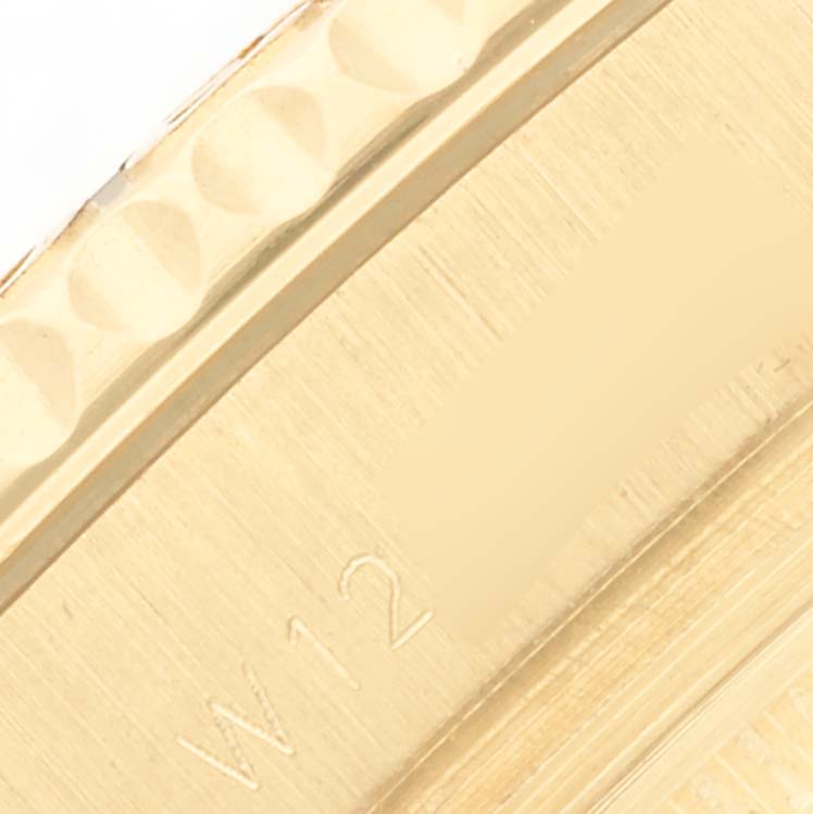 The image shows a close-up of the gold bezel edge of a Rolex Yacht-Master 68628 Men's Yellow Gold White Dial 68628 Men's Yellow Gold White Dial watch.