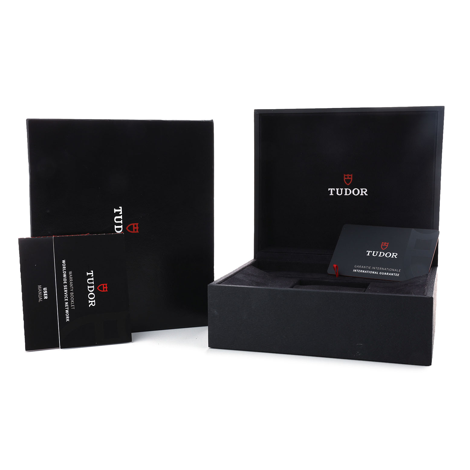 The image shows a Tudor 1926 M91450-0001 Men's Stainless Steel Silver Dial watch box, open with manuals and a warranty card visible.