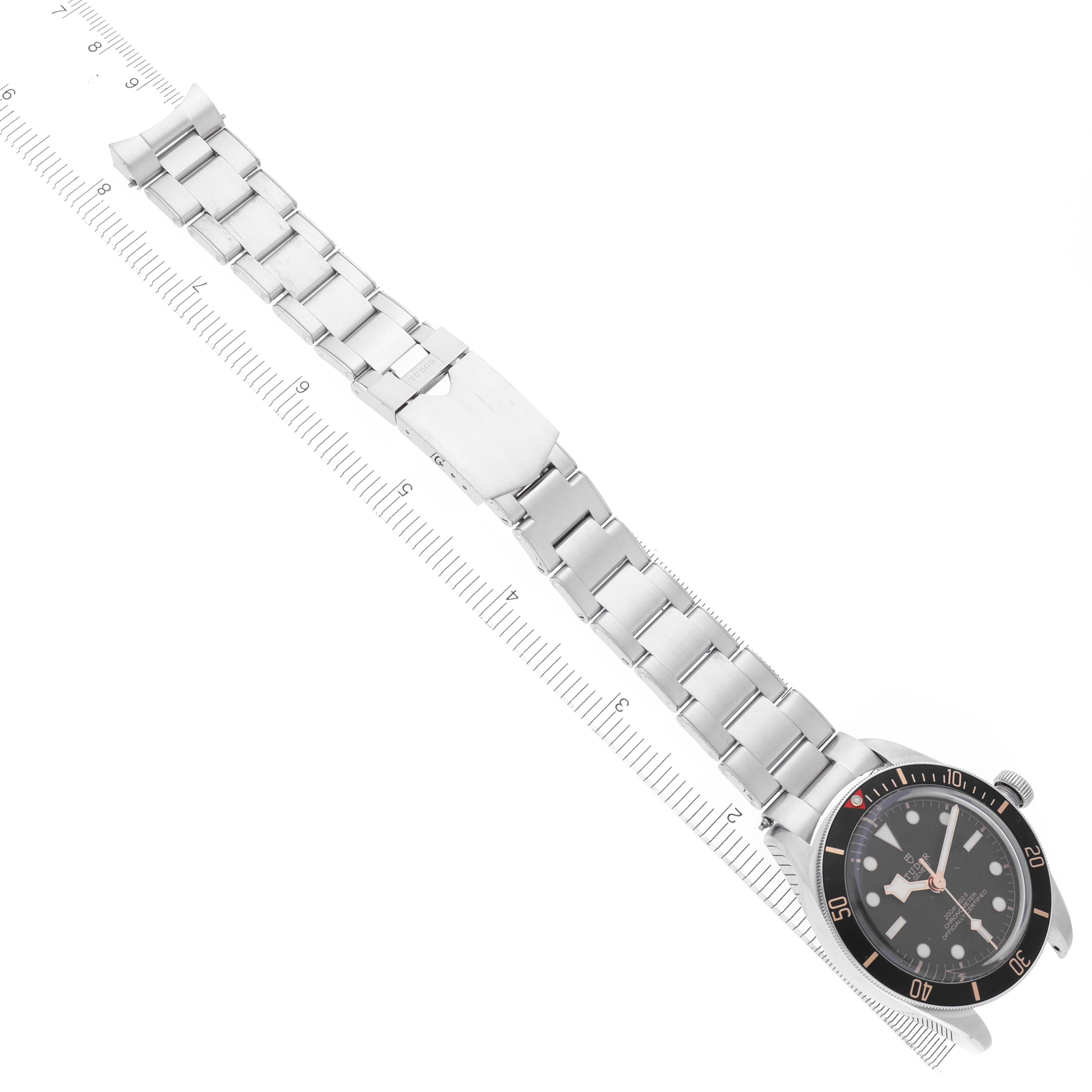 The Tudor Heritage Black Bay 79030 Men's Stainless Steel Black Dial 79030 Men's Stainless Steel Black Dial watch is shown from a top-down angle, revealing the face, bezel, and full metal bracelet.