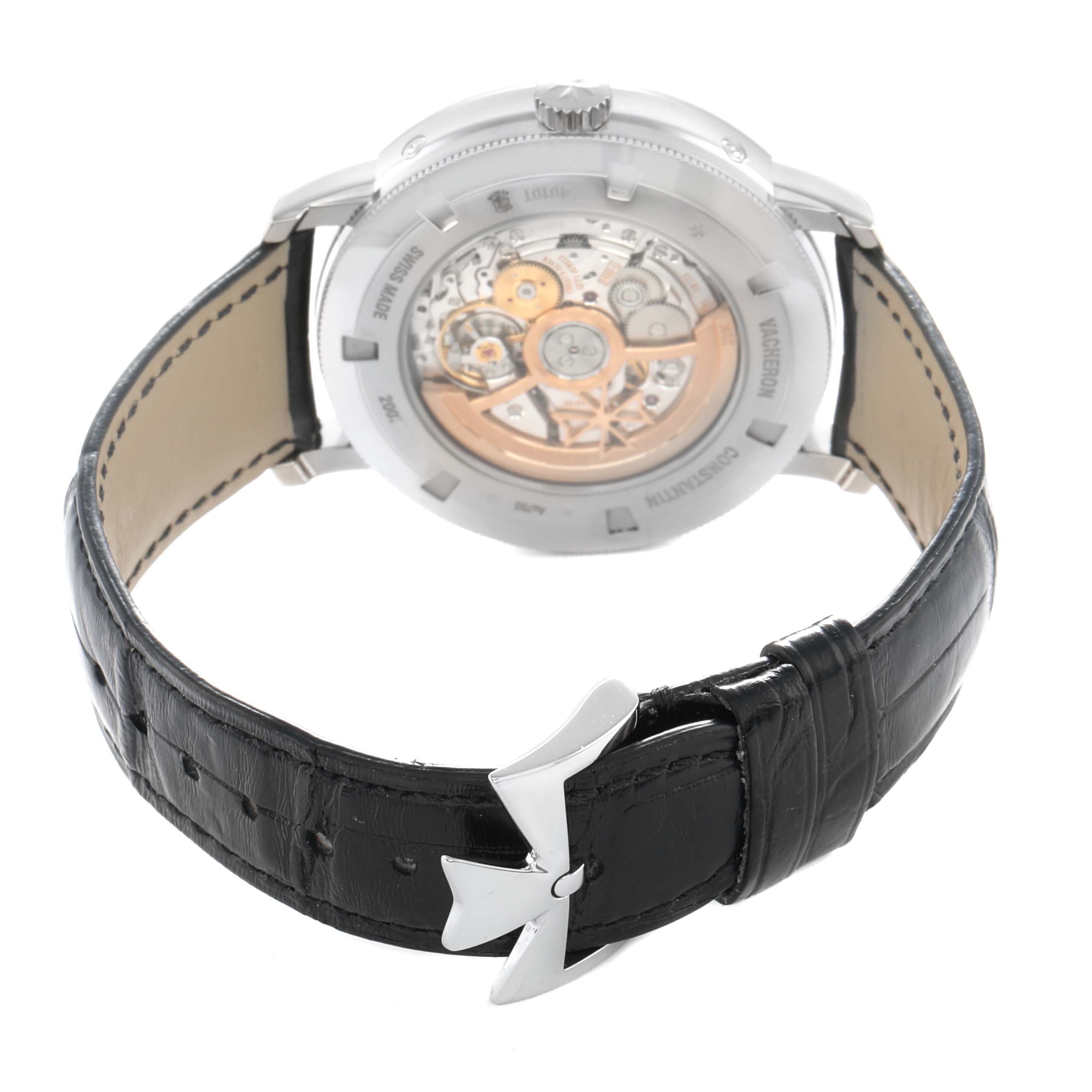 The Vacheron Constantin Traditionnelle 4010T/000G Men
s White Gold Grey Dial watch is shown from the back, highlighting the open case back and leather strap with a distinct clasp.