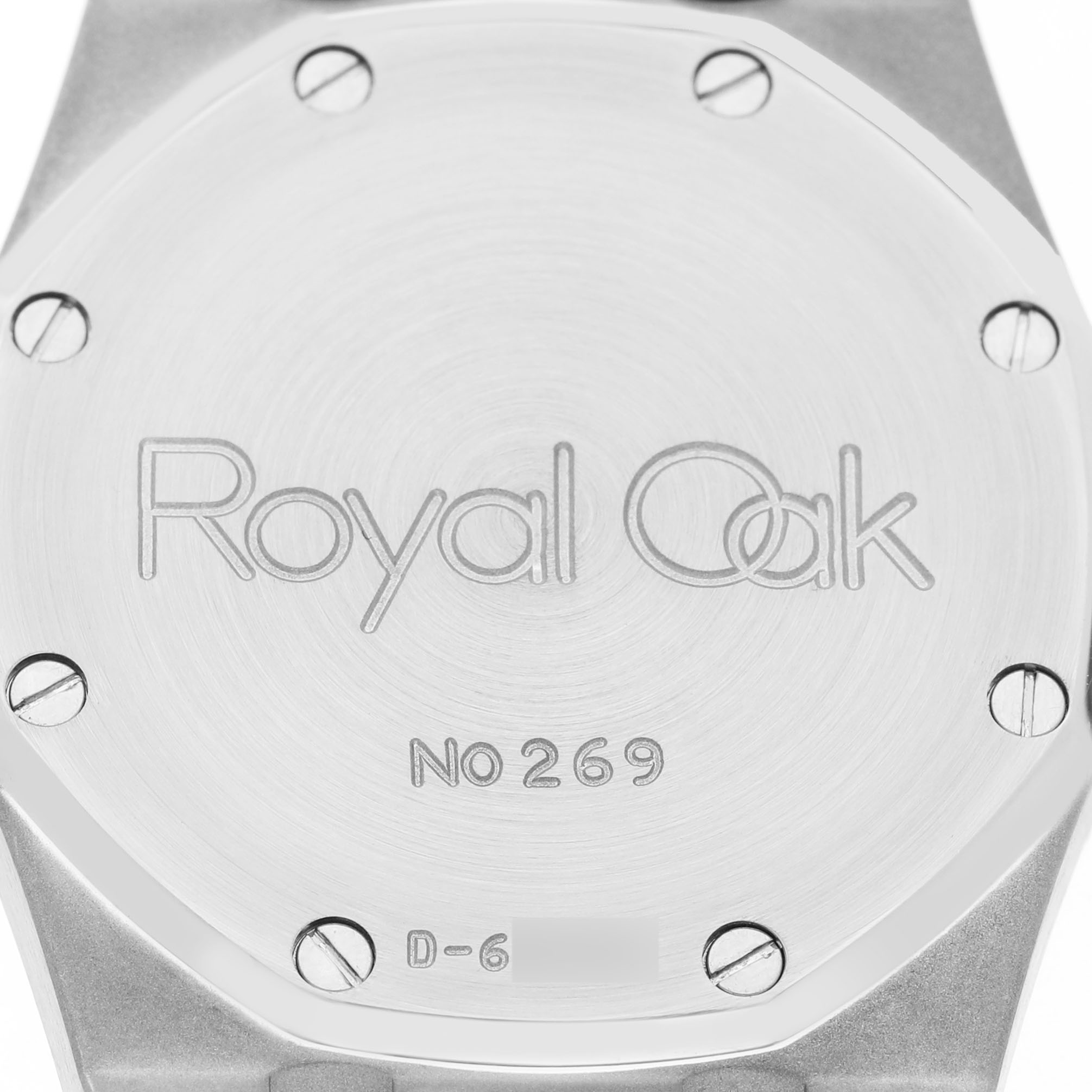The image shows the back case of an Audemars Piguet Royal Oak 14100SA Men's Steel and Gold (two tone) Grey Dial watch, displaying engraved text and screws.