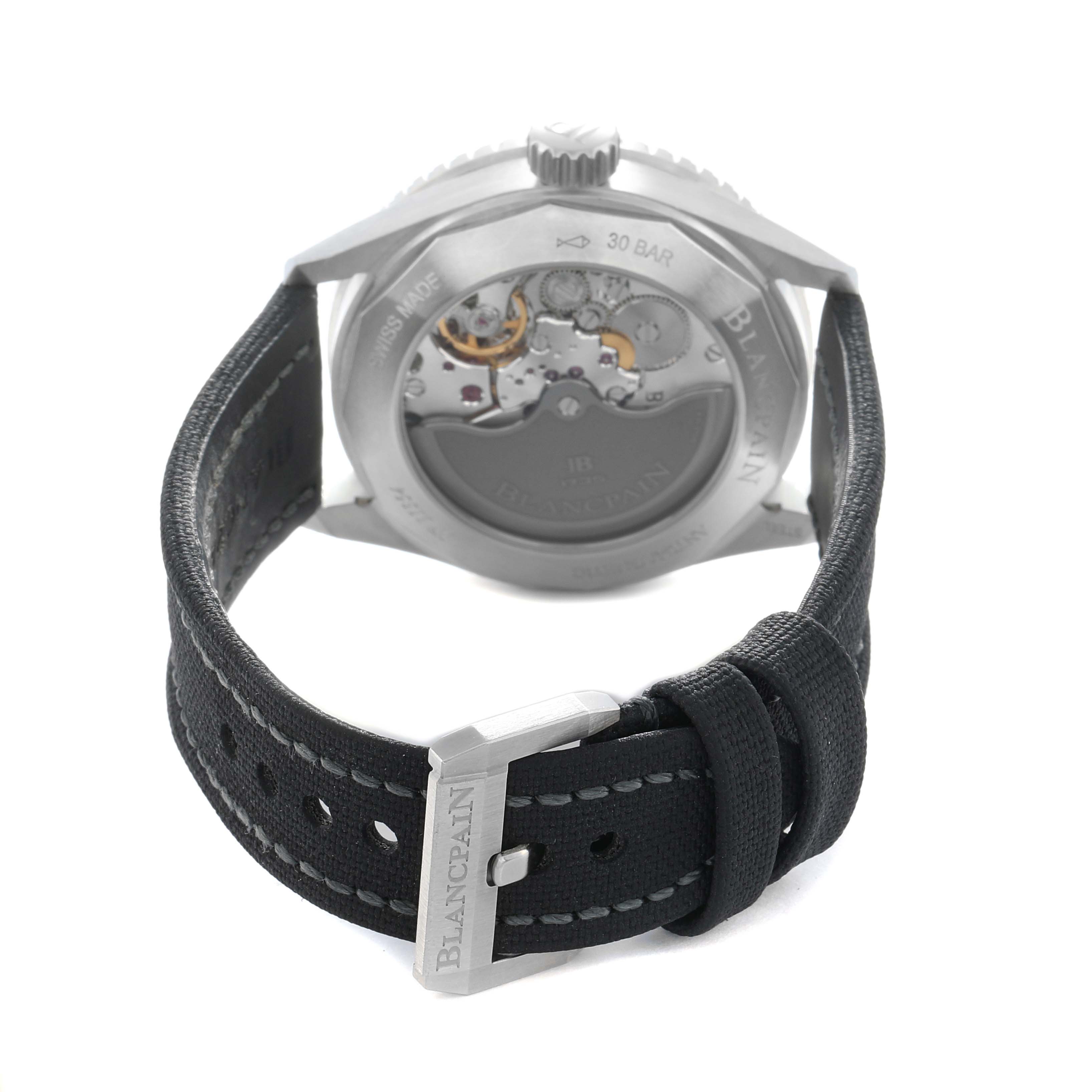The Blancpain Fifty Fathoms 5100B-1110-B52A Men
s Stainless Steel Grey Dial watch is shown from the back, revealing the caseback, movement, and strap with buckle.
