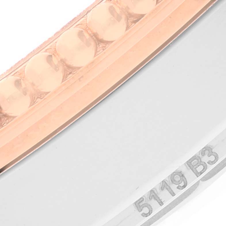 This close-up image of the Breitling Navitimer U17326211M1P1 Men
s Stainless Steel Grey Dial U17326211M1P1 Men
s Stainless Steel Grey Dial watch shows a partial view of the bezel and the edge of the case with some engravings.