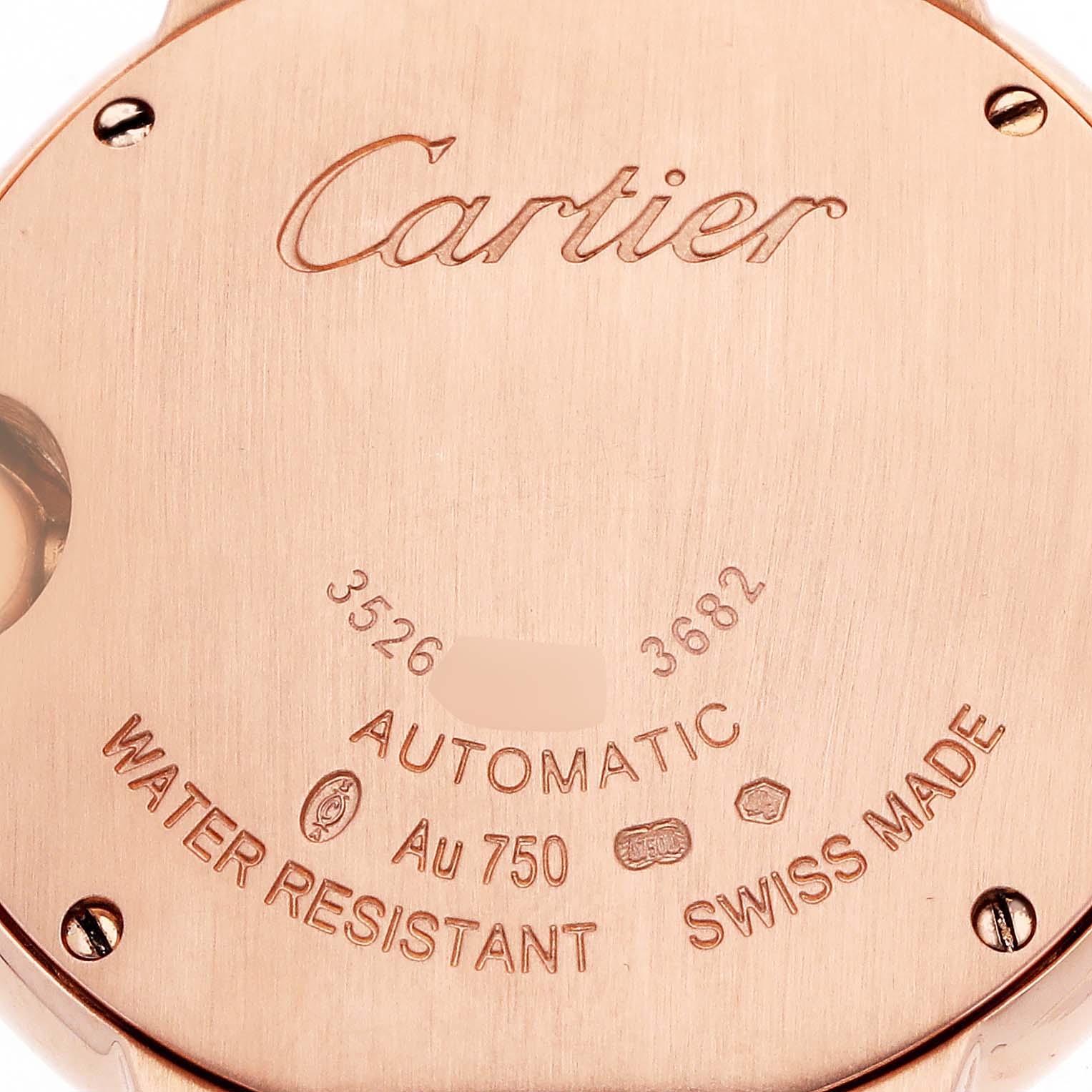 The image shows the back case of a Cartier Ballon Bleu W6920096 Women's Rose Gold Silver Dial watch, featuring inscriptions about its specifications and branding.