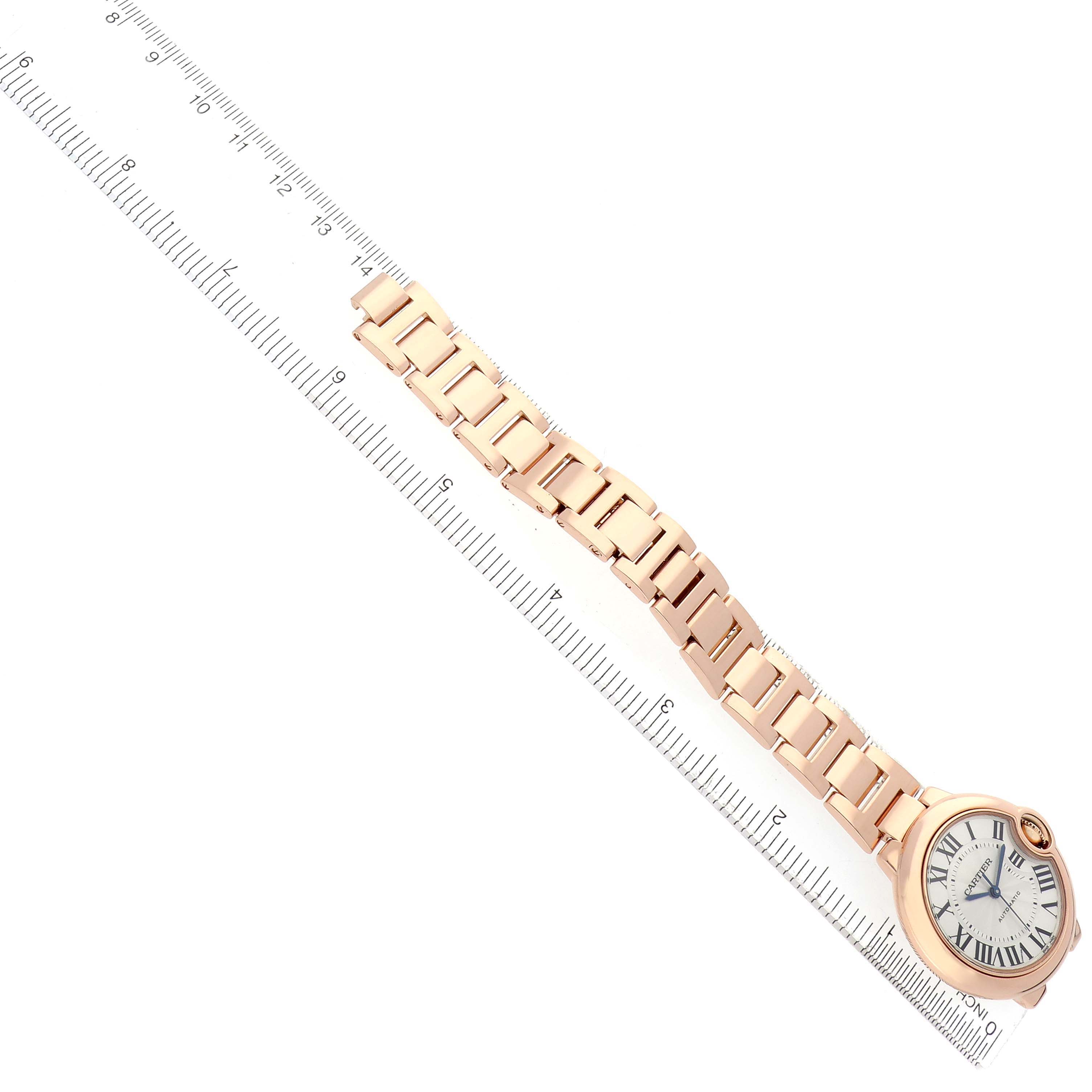 The image shows a Cartier Ballon Bleu W6920096 Women's Rose Gold Silver Dial watch from an angled top view, featuring the watch face, bracelet, and a ruler for scale.