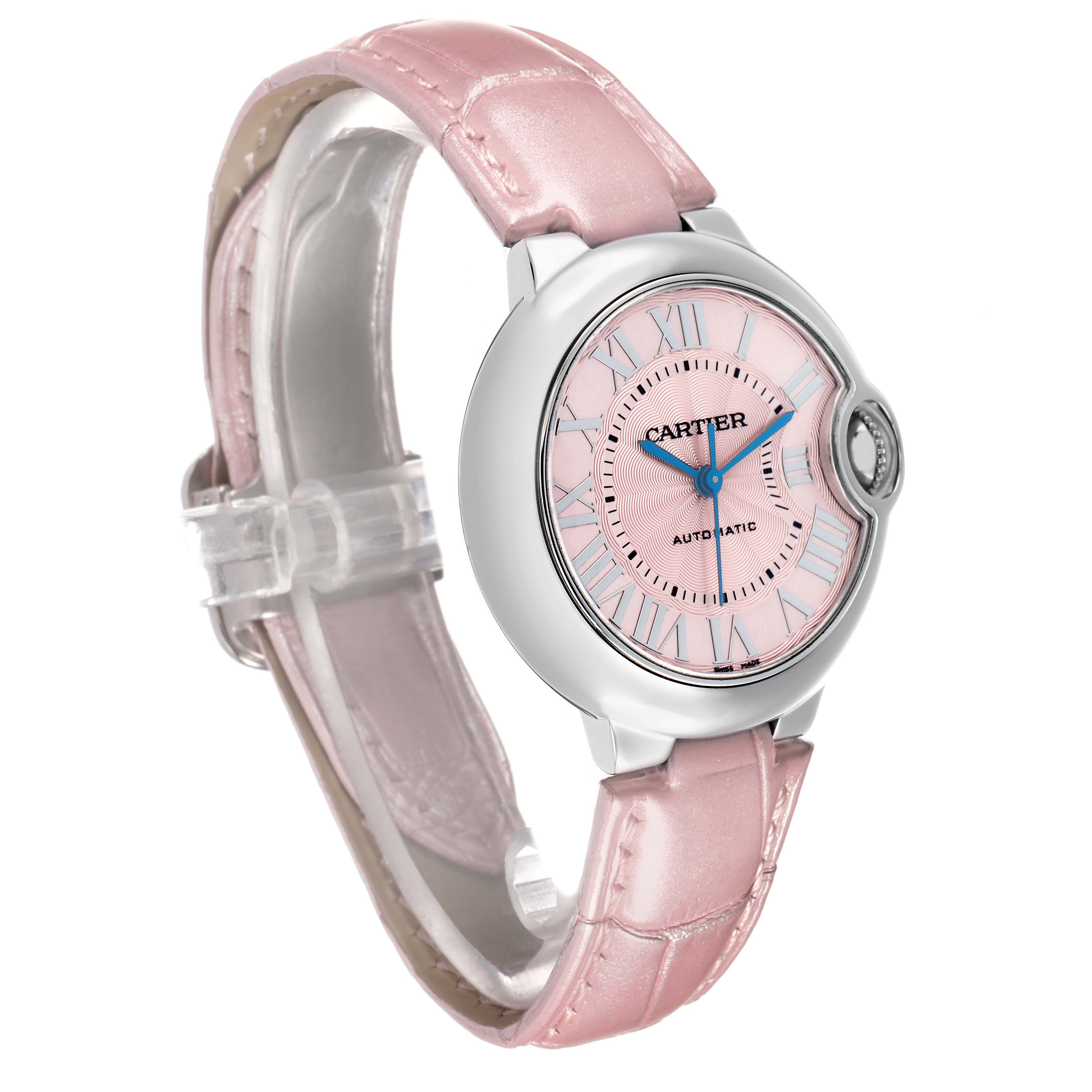 The Cartier Ballon Bleu WSBB0002 Women's Stainless Steel Pink Dial watch is shown at an angle highlighting its pink strap, silver case, and pink dial with Roman numerals.