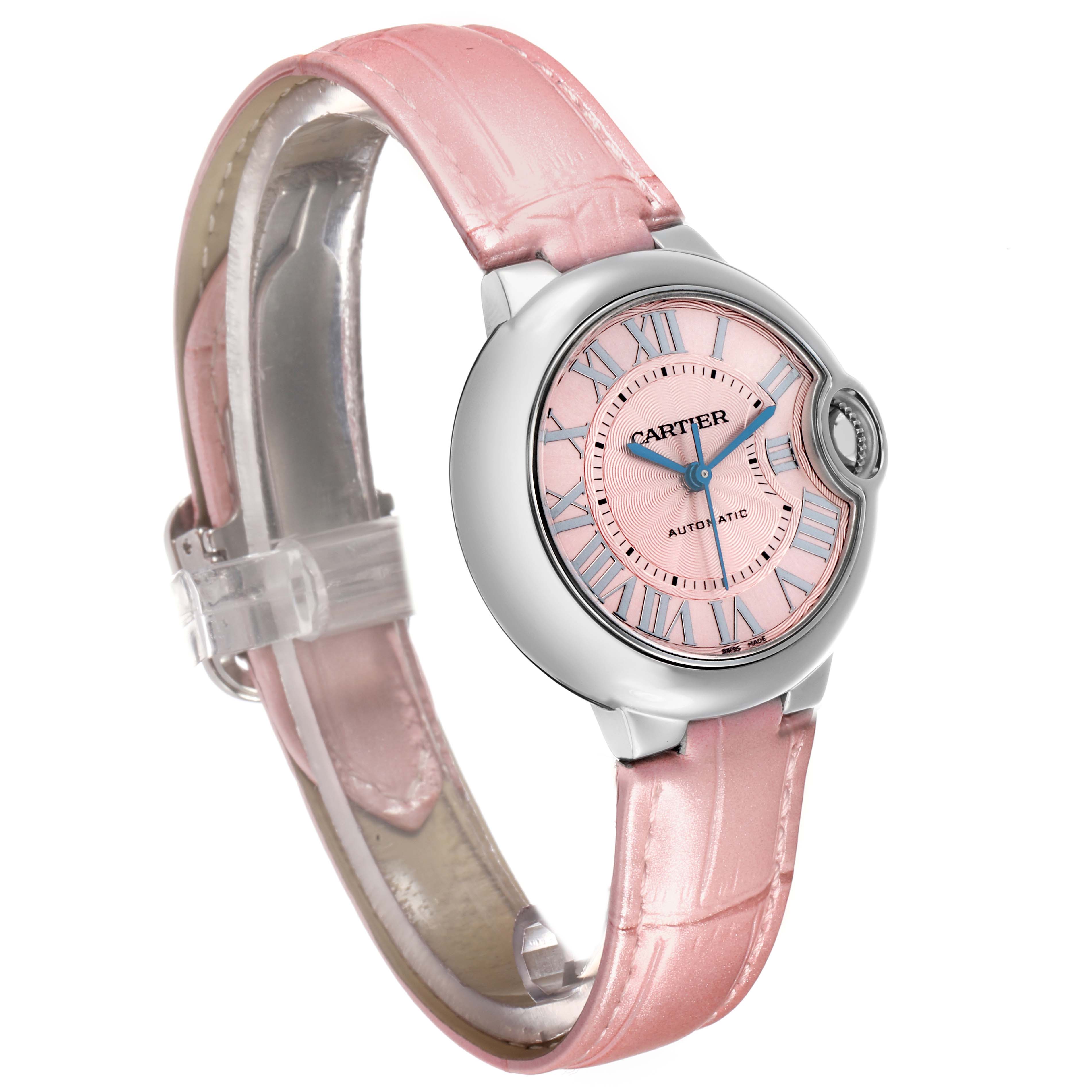 The Cartier Ballon Bleu WSBB0002 Women's Stainless Steel Pink Dial watch is shown at a three-quarter angle, displaying its pink dial, Roman numerals, and pink leather strap.