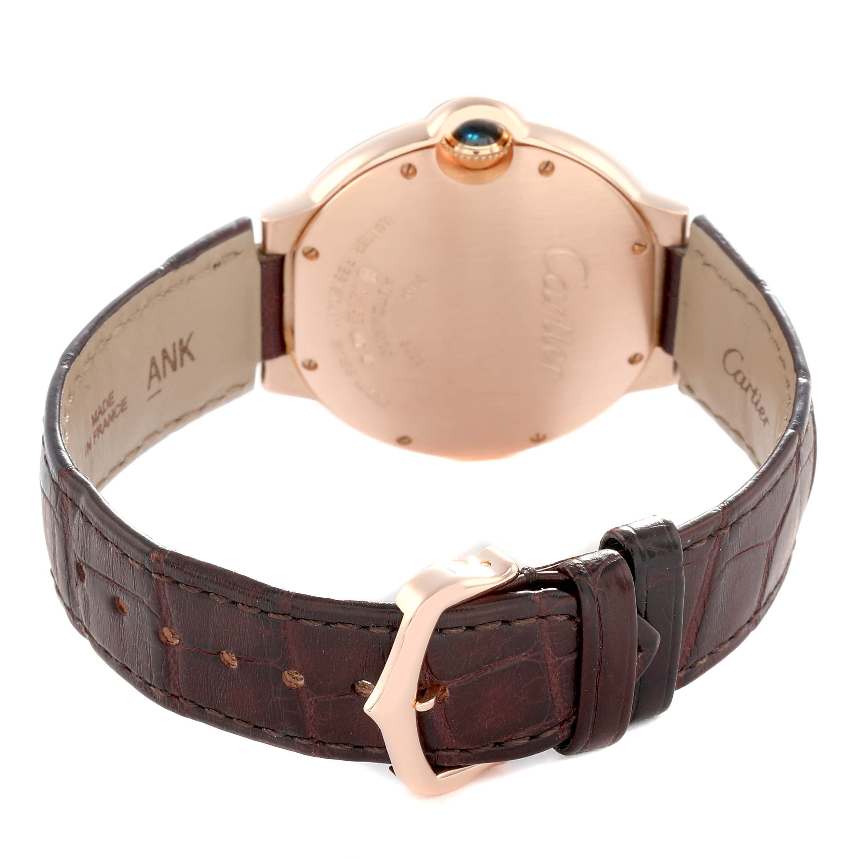 The image shows the back view of a Cartier Ballon Bleu WE902026 Women
s Rose Gold Silver Dial watch, highlighting the case, crown, and brown leather strap with buckle.
