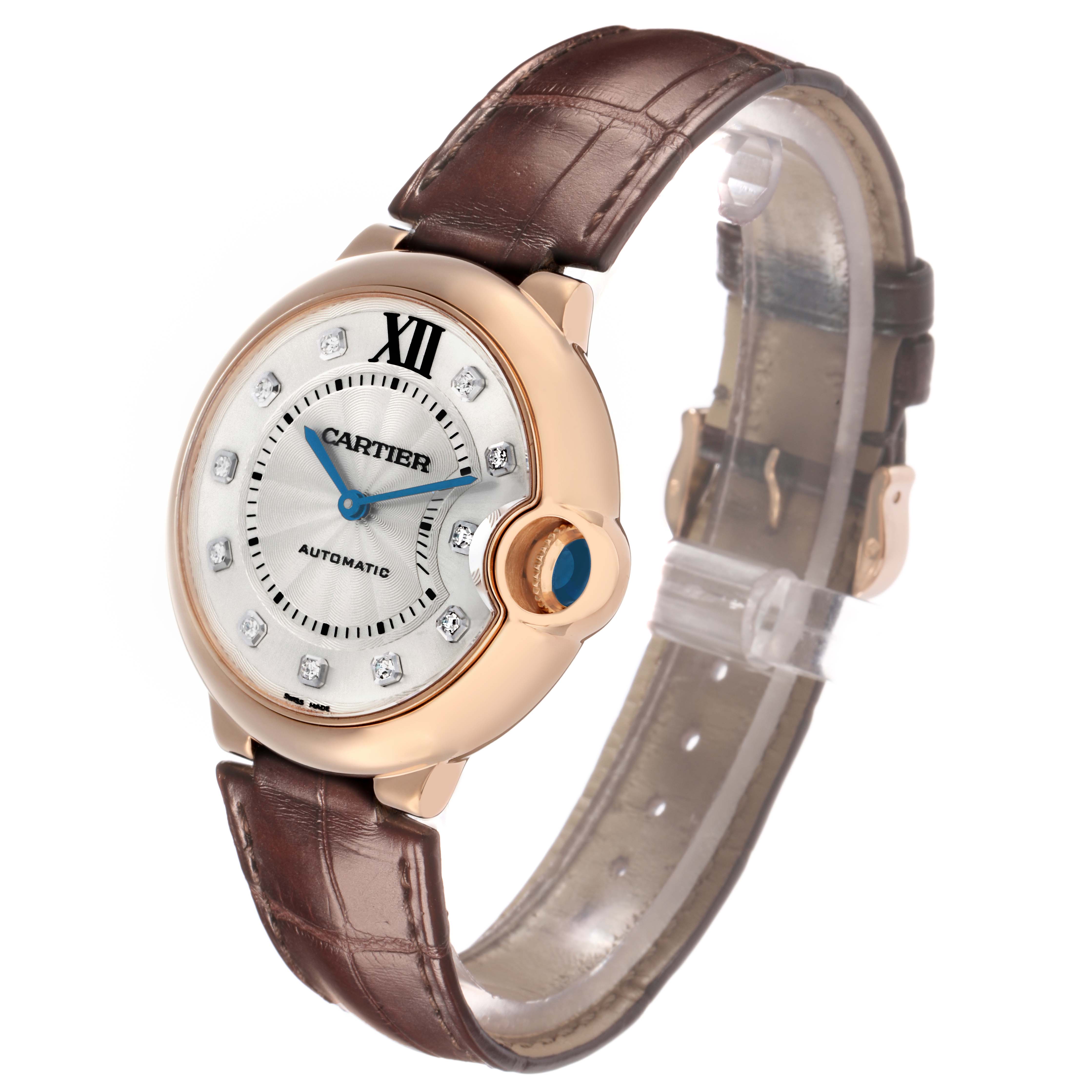 The Ballon Bleu by Cartier is shown at a three-quarter angle, displaying the face, crown, and brown leather strap.