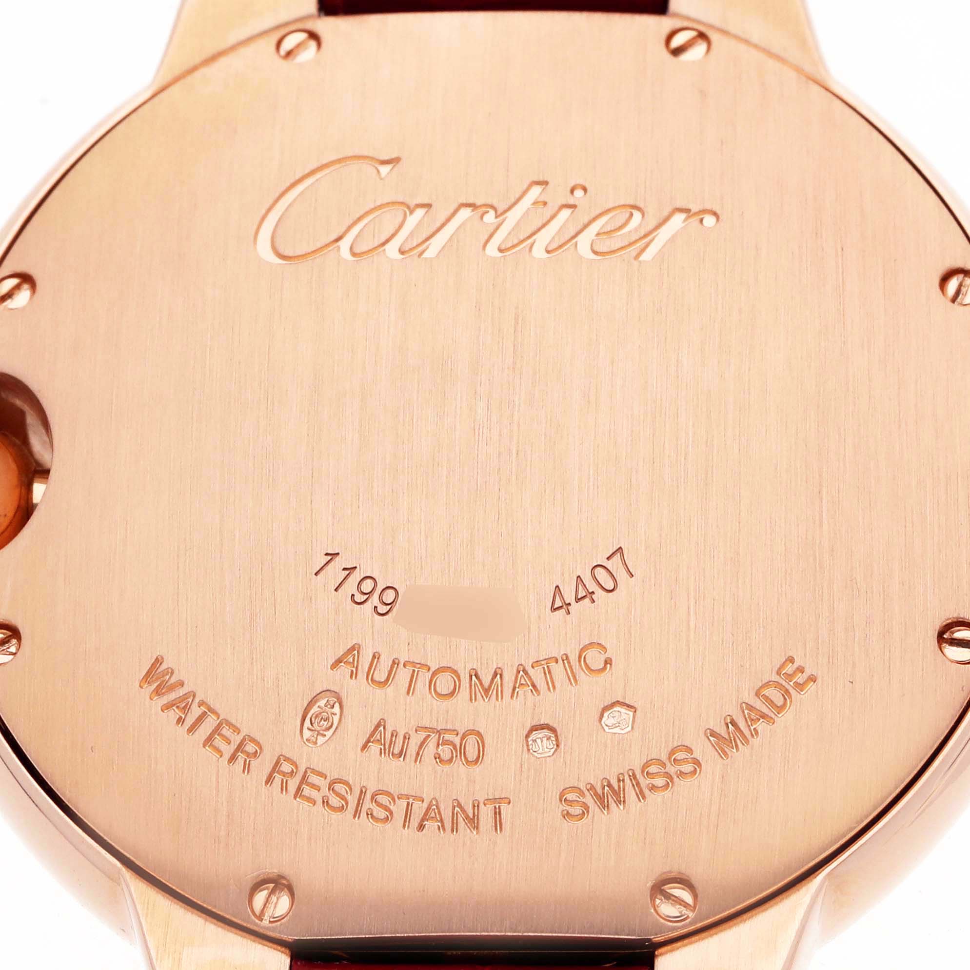 The image shows the backside of a Cartier Ballon Bleu WGBB0053 Men's Rose Gold Silver Dial watch, highlighting engravings and metal details.