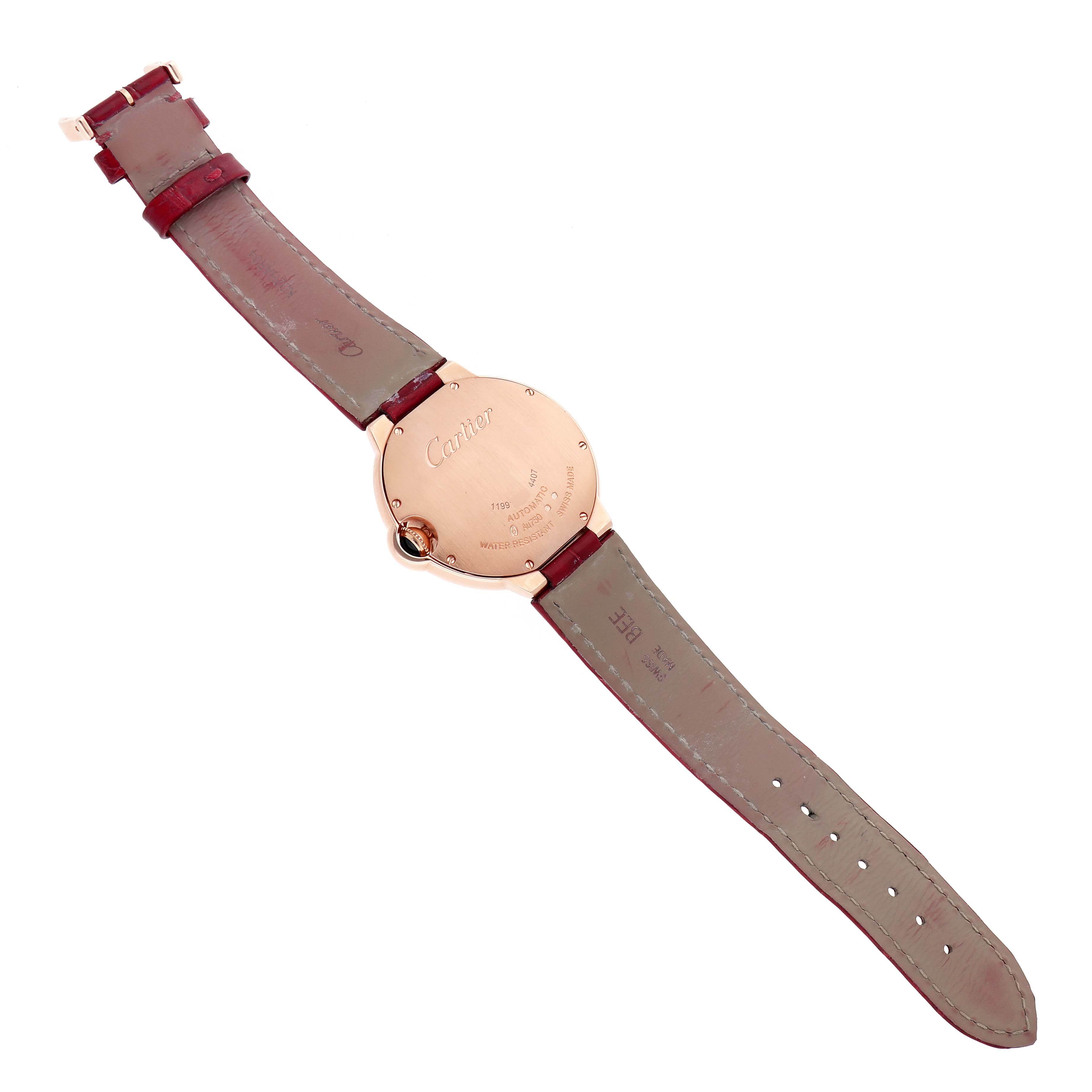 The image shows the back view of a Cartier Ballon Bleu WGBB0053 Men's Rose Gold Silver Dial watch with a leather strap and visible engravings on the case back.