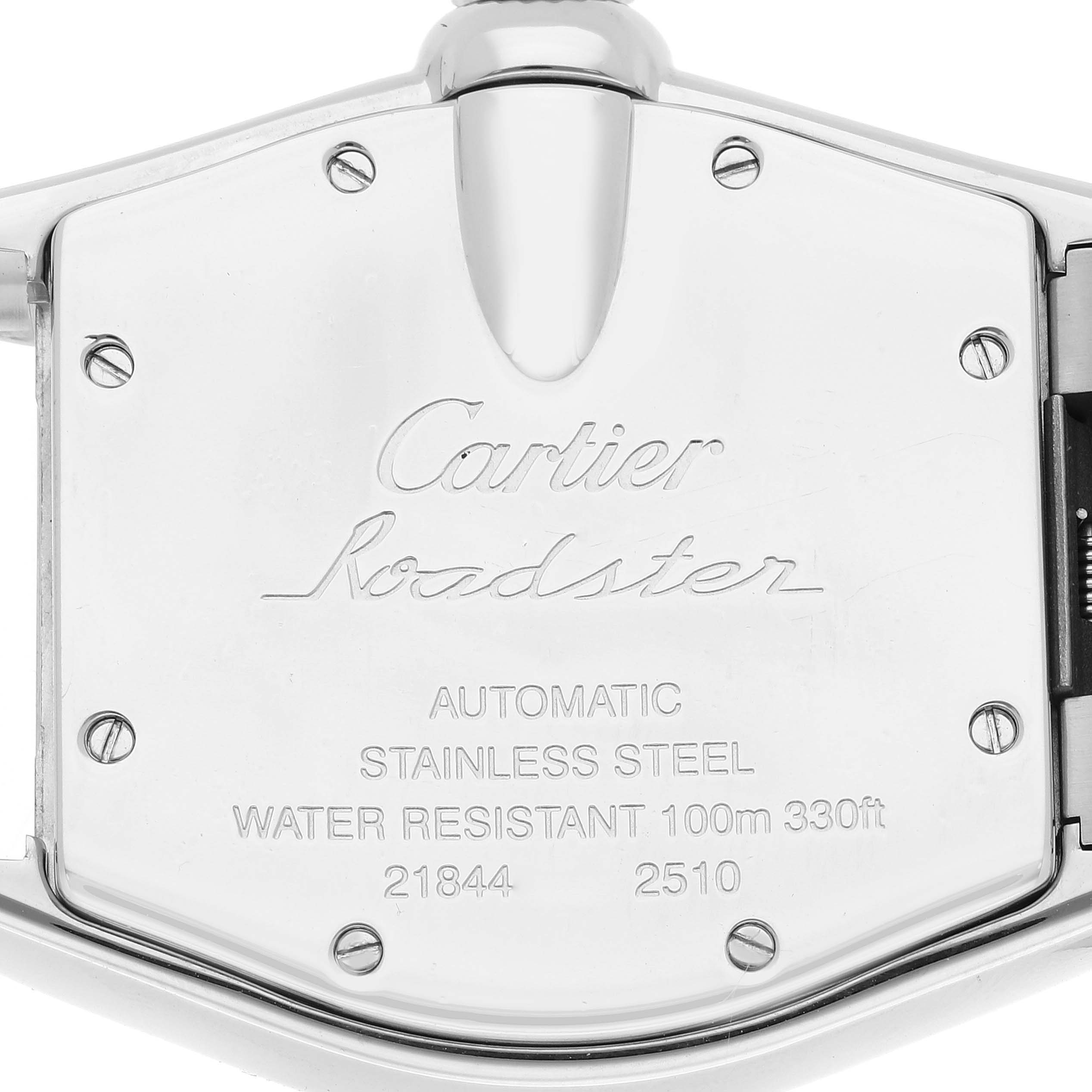 The image shows the case back of a Cartier Roadster W62002V3 Men's Stainless Steel Black Dial W62002V3 Men's Stainless Steel Black Dial watch, displaying its inscriptions and screws.
