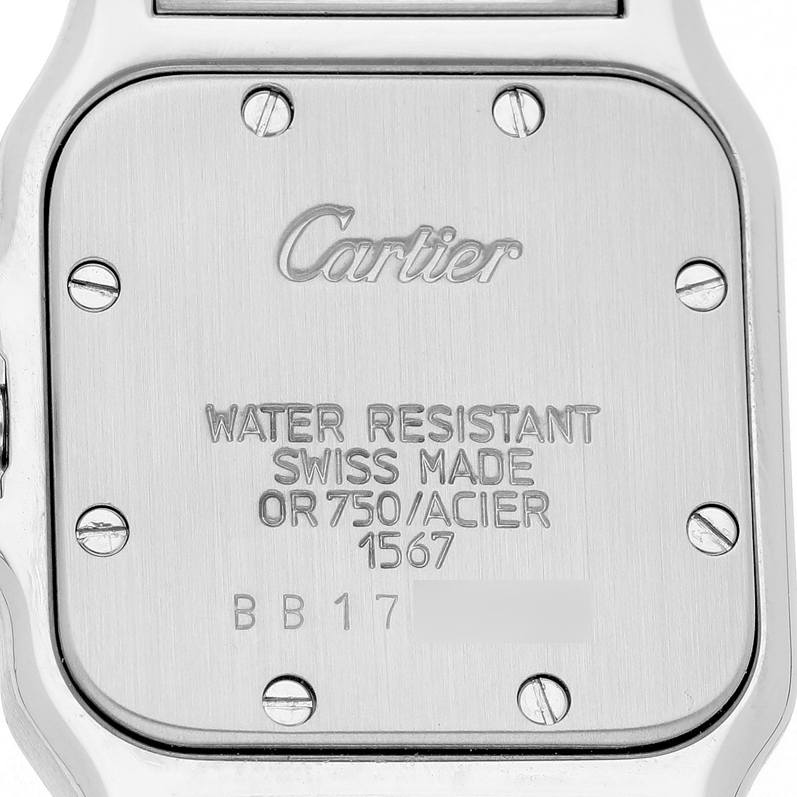 The image shows the back case of the Cartier Santos W20012C4 Women's Stainless Steel Silver Dial watch, highlighting text and screws.