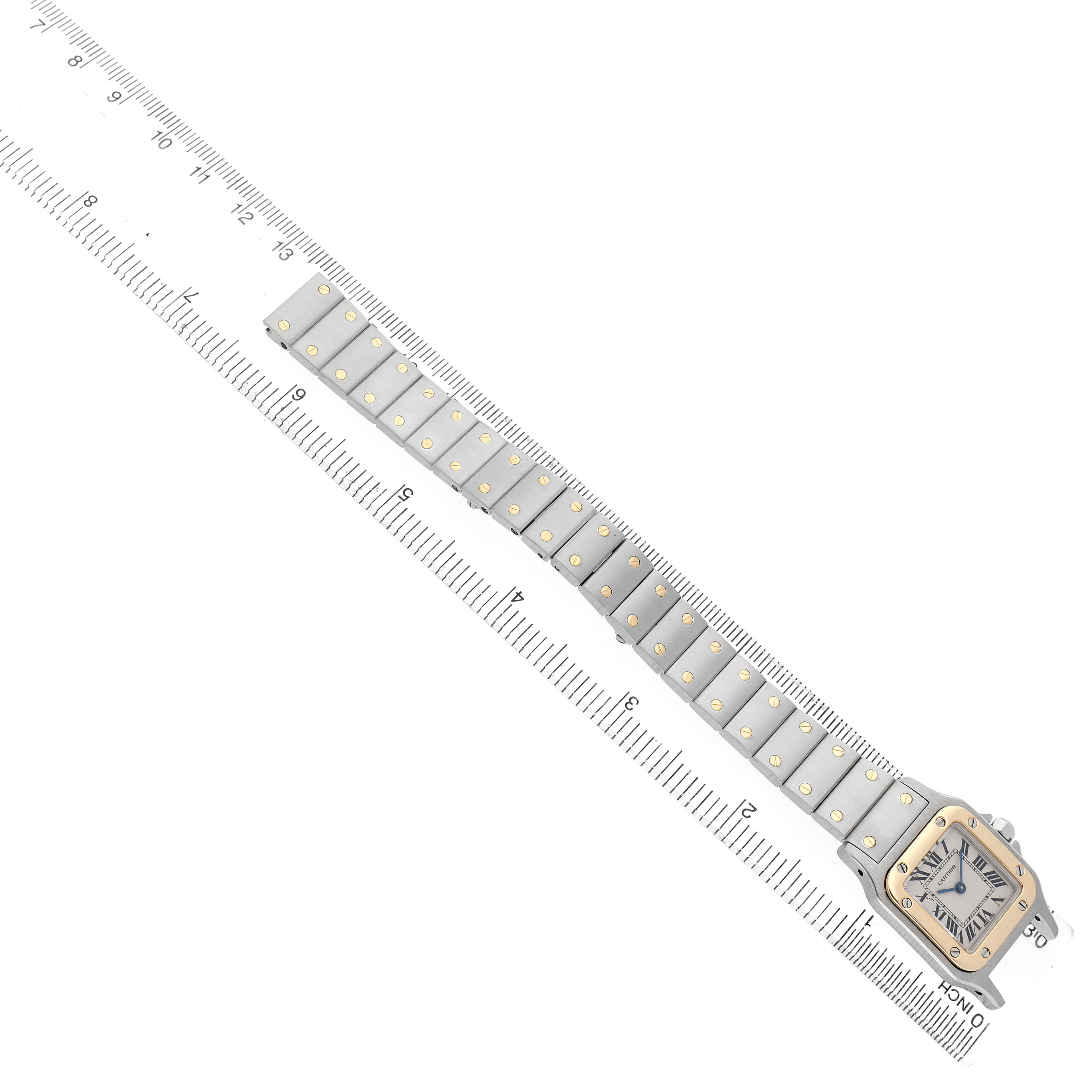 The Cartier Santos W20012C4 Women's Stainless Steel Silver Dial watch is shown from an overhead angle, displaying the face, bezel, and full bracelet with a ruler for scale.