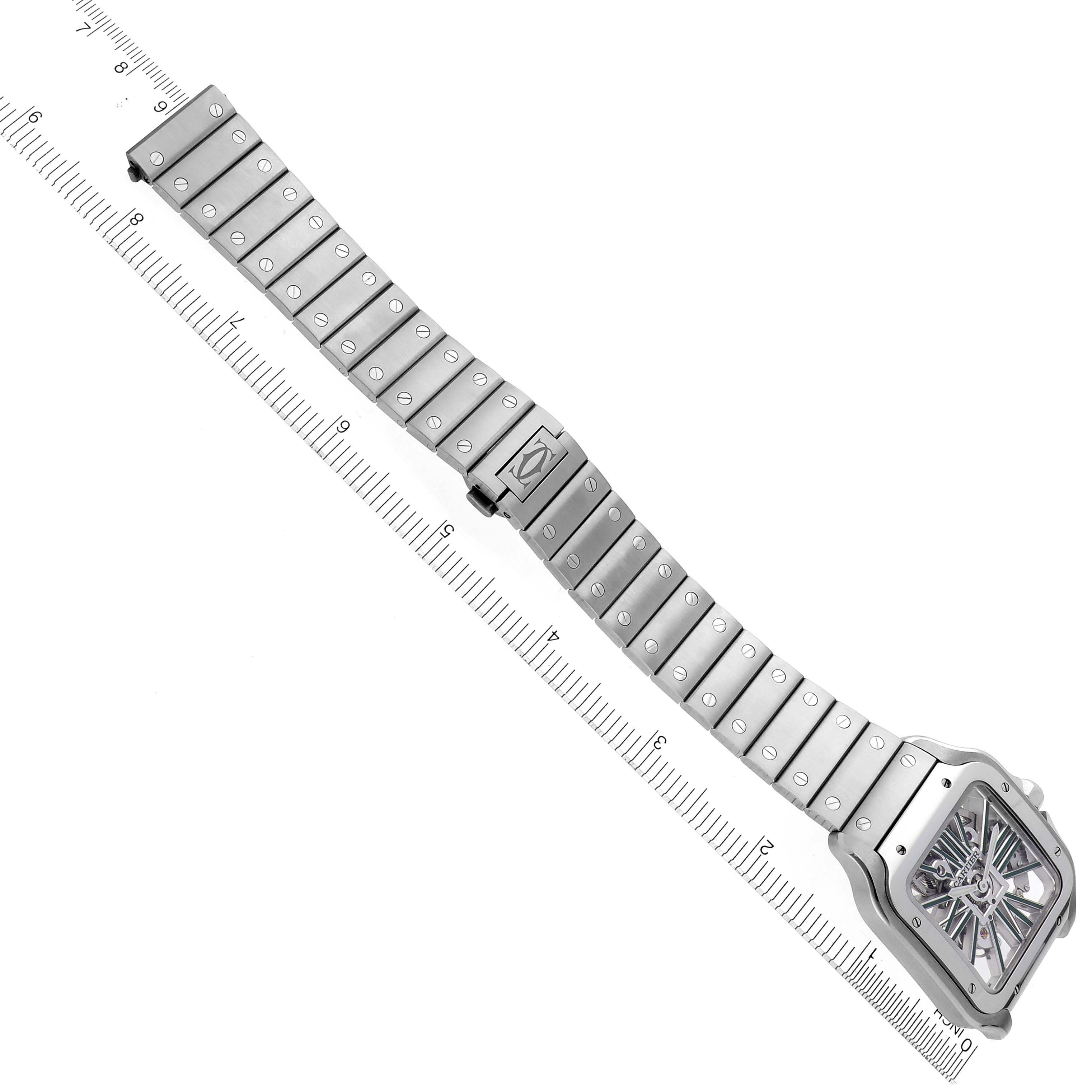 The Cartier Santos WHSA0028 Men's Stainless Steel Transparent Dial WHSA0028 Men's Stainless Steel Transparent Dial watch is shown from an overhead angle, displaying its full bracelet and dial next to a ruler.