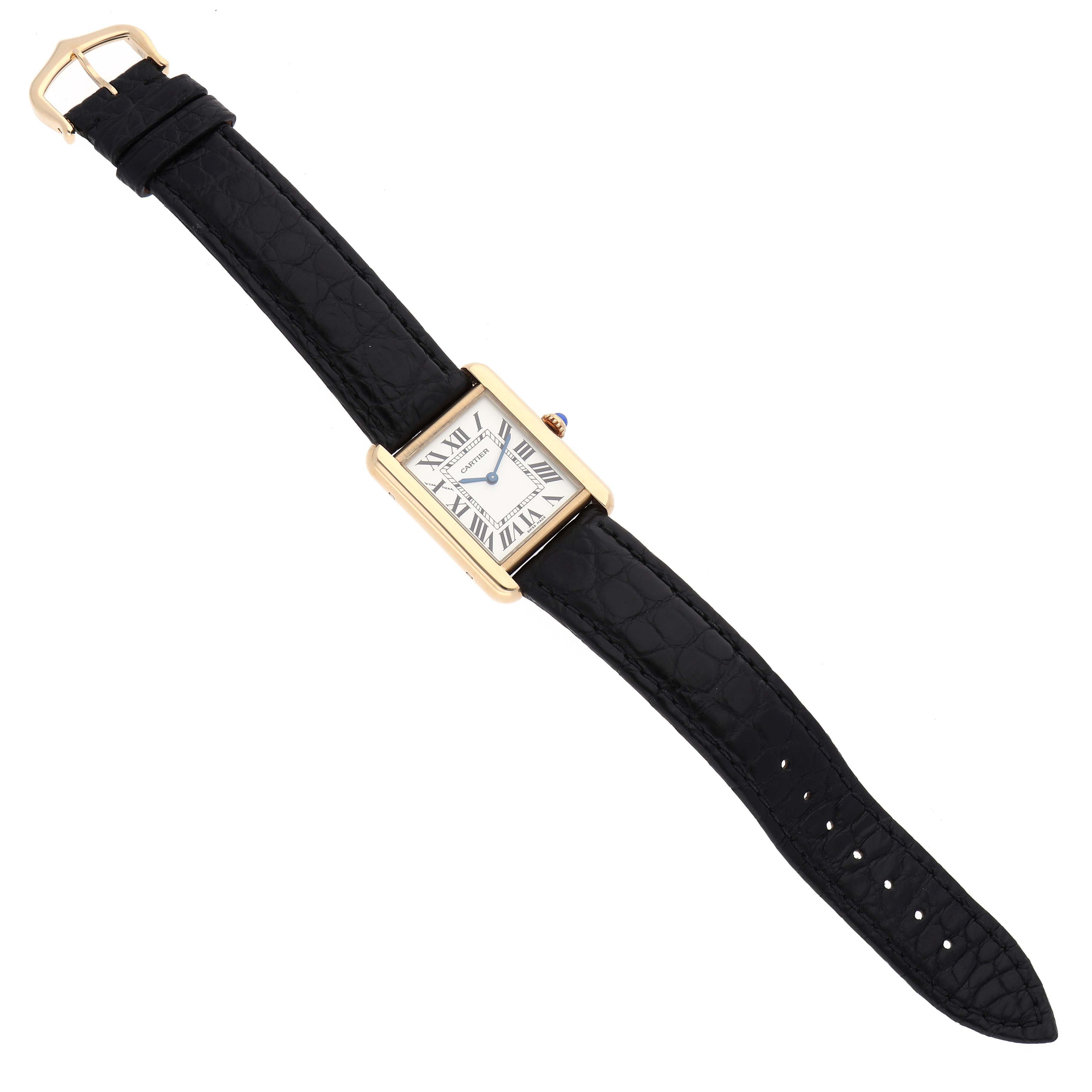 The Cartier Tank Solo W1018755 Women's Steel and Gold (two tone) Silver Dial watch is shown from a top-down angle, displaying its rectangular face and black leather strap.