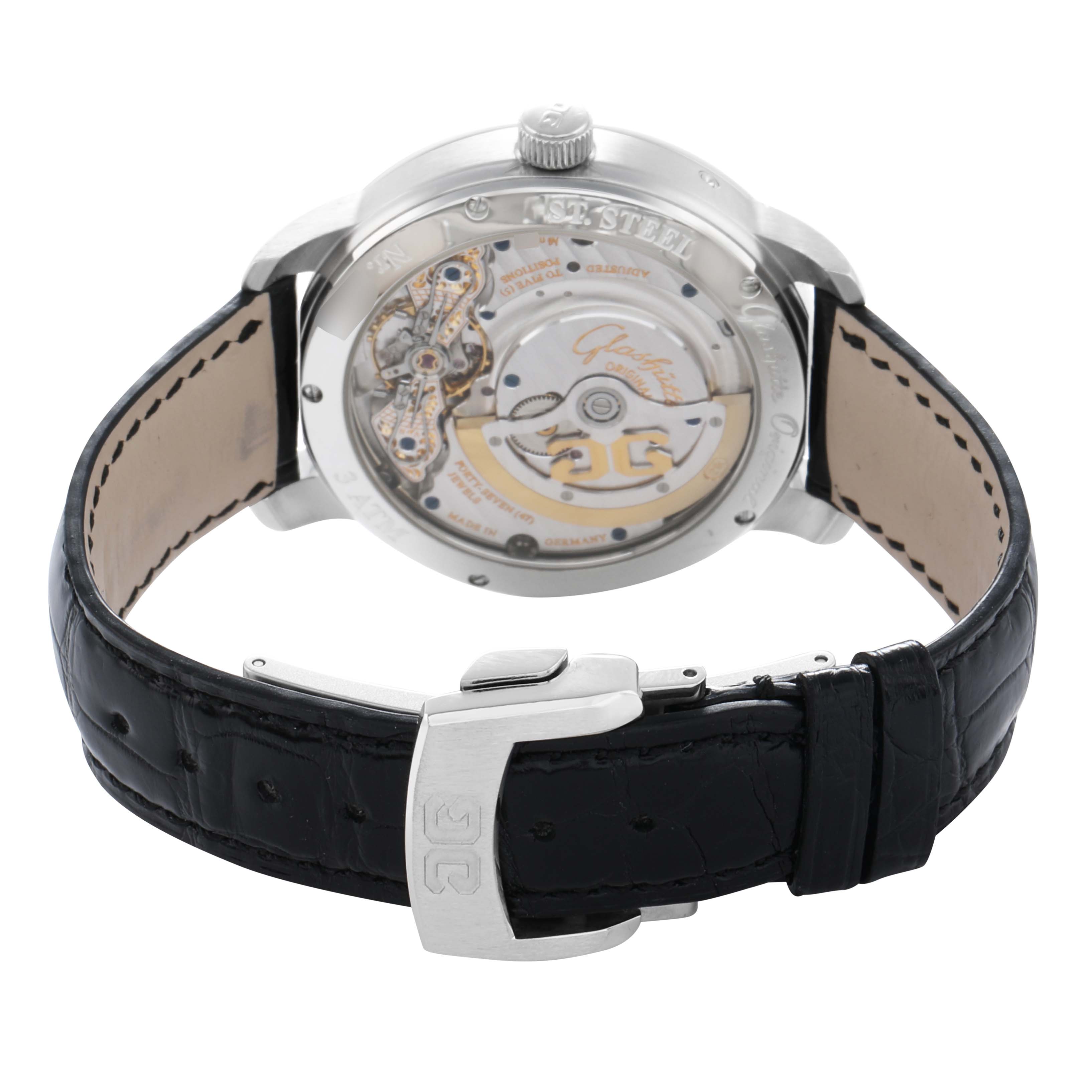 The Glashütte Pano watch is shown from the back, displaying the movement through a transparent case and a black leather strap.