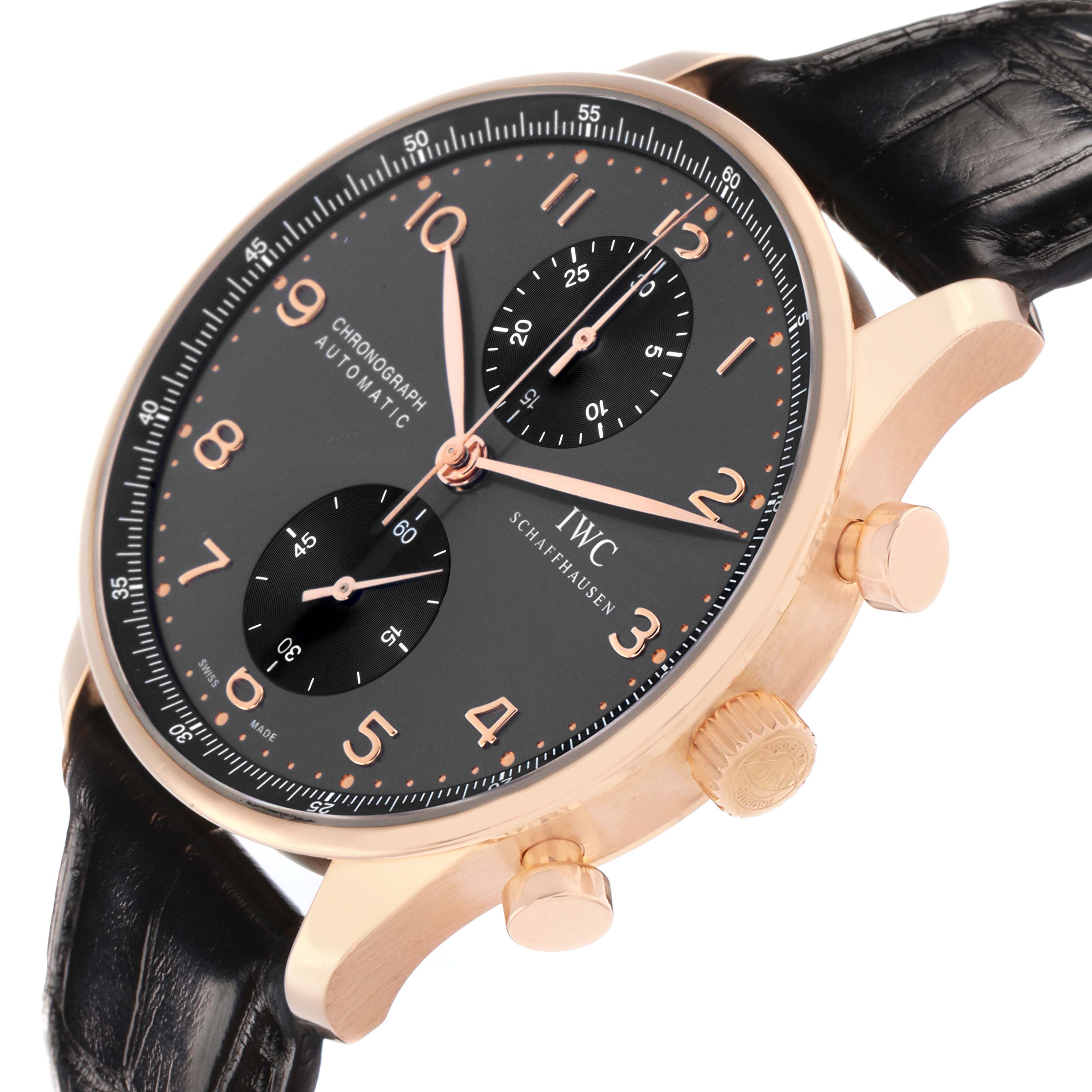 The IWC Portuguese IW371482 Men
s Rose Gold Grey Dial watch is shown at an angle showing the face, case, crown, and pushers with a side view of the leather strap.