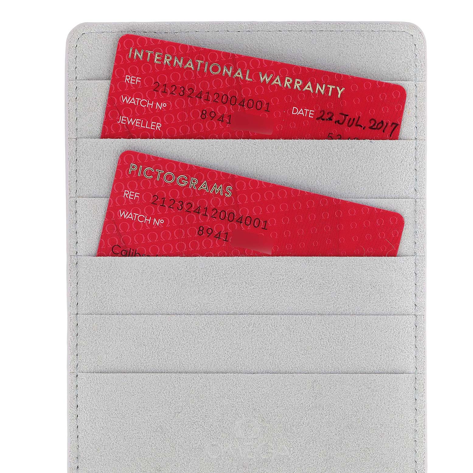 The image shows international warranty and pictogram cards for the Omega Seamaster 212.32.41.20.04.001 Men's Stainless Steel White Dial 212.32.41.20.04.001 Men's Stainless Steel White Dial watch, placed in a cardholder.