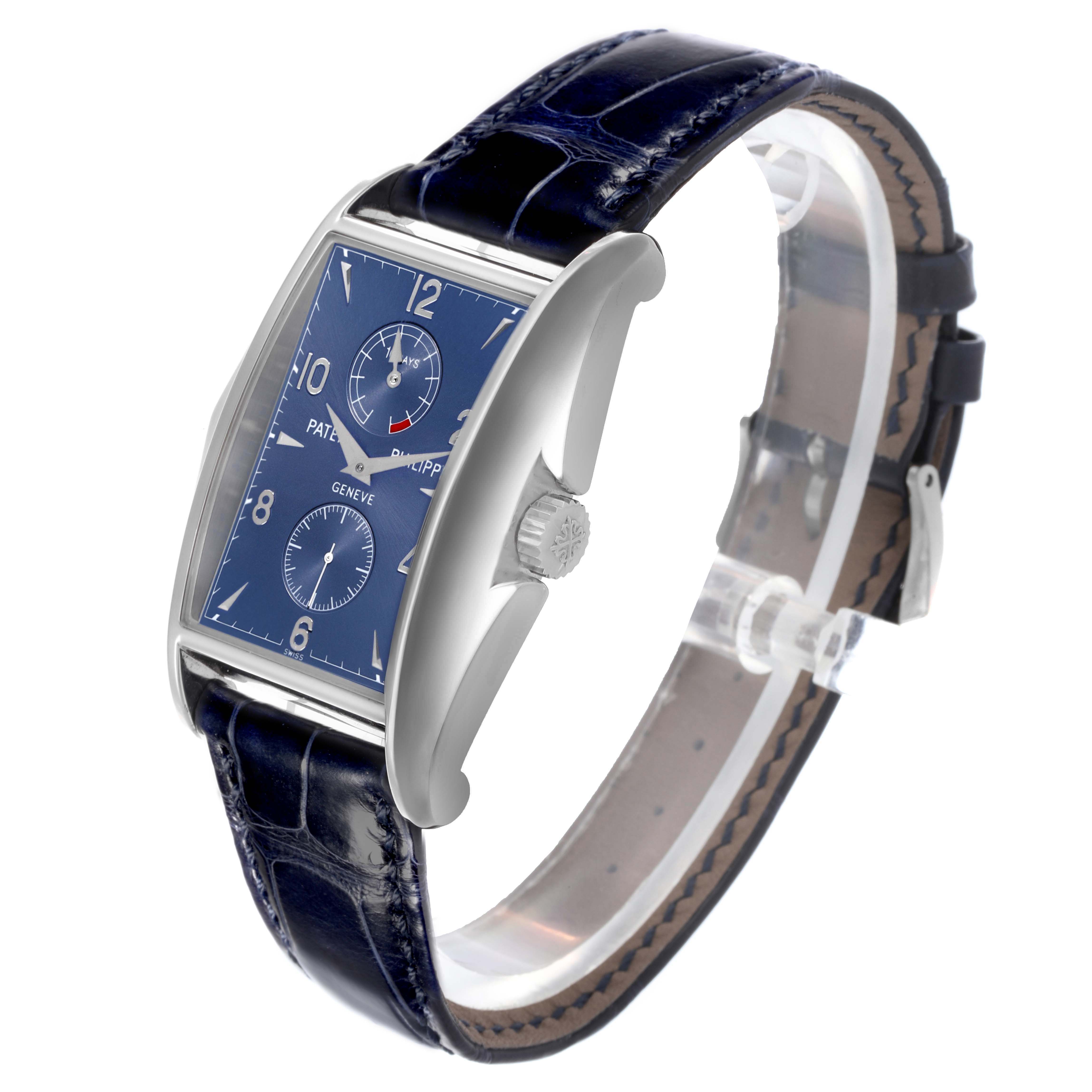 The Patek Philippe Gondolo 5100G - 001 Men's White Gold Blue Dial watch is shown at a three-quarter angle, displaying its dial, case, crown, and leather strap.