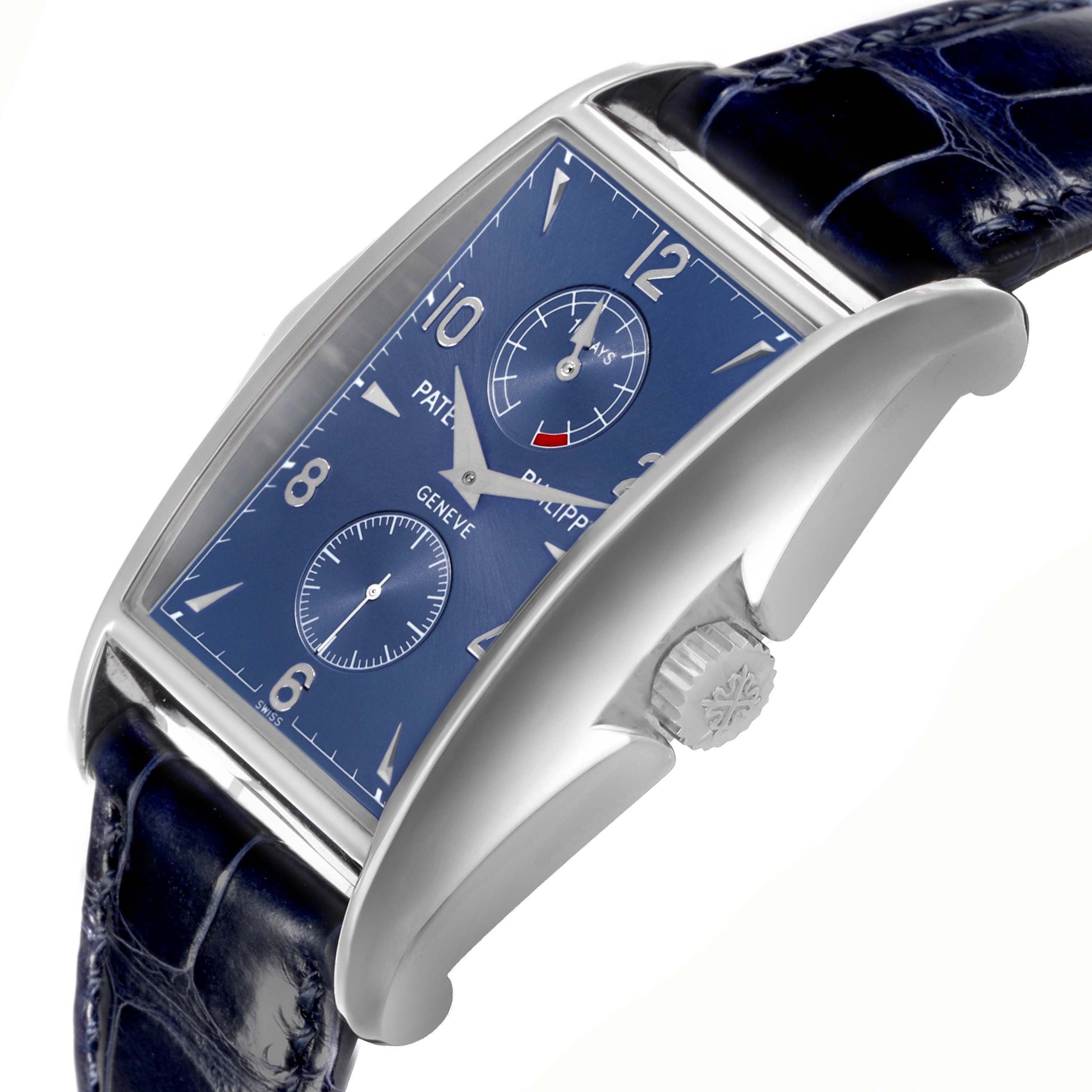 The Patek Philippe Gondolo 5100G - 001 Men's White Gold Blue Dial watch is shown at a diagonal angle, displaying its blue dial, crown, case, and partial strap.