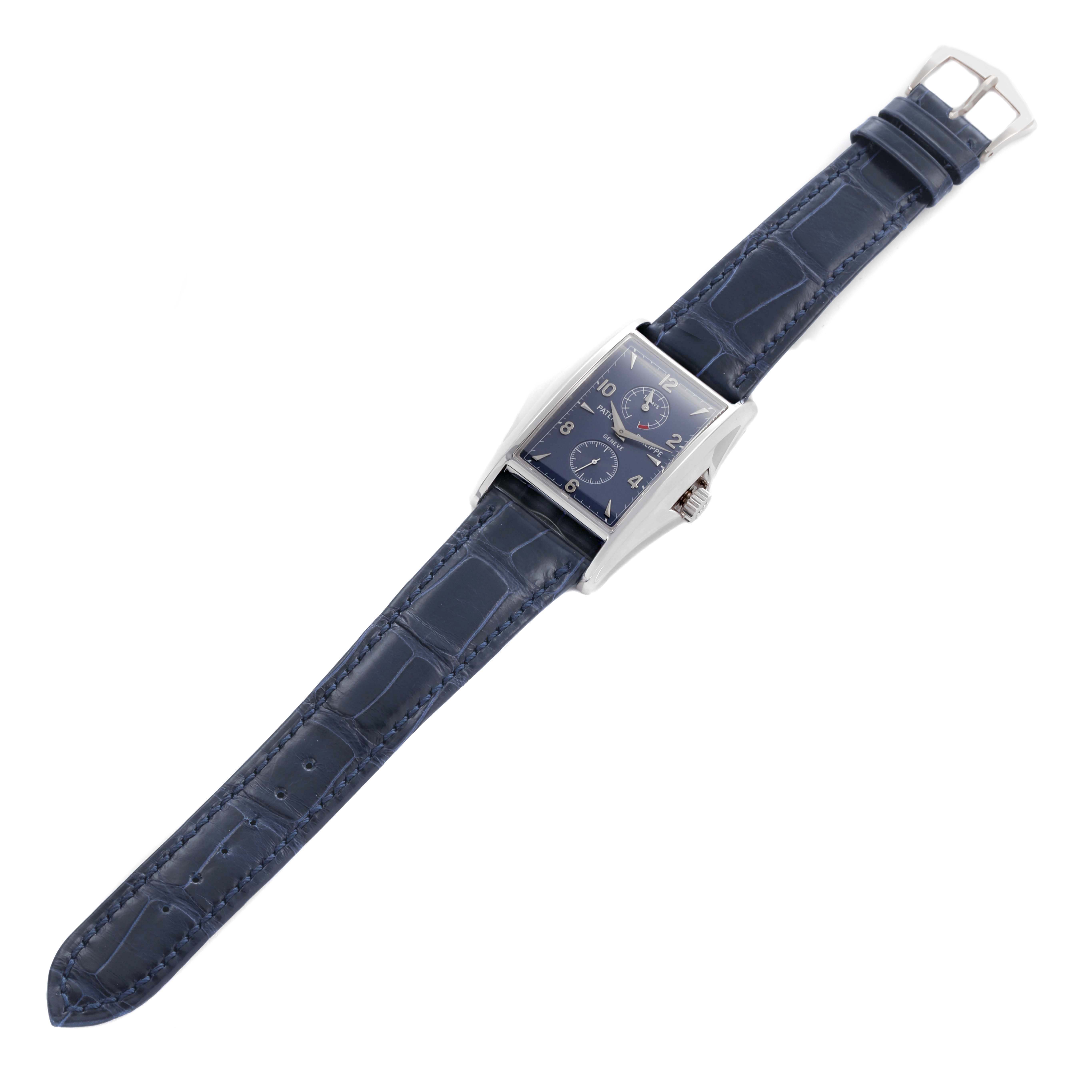 The Patek Philippe Gondolo 5100G - 001 Men's White Gold Blue Dial watch is shown from a top-down angle, highlighting its rectangular dial and blue leather strap.