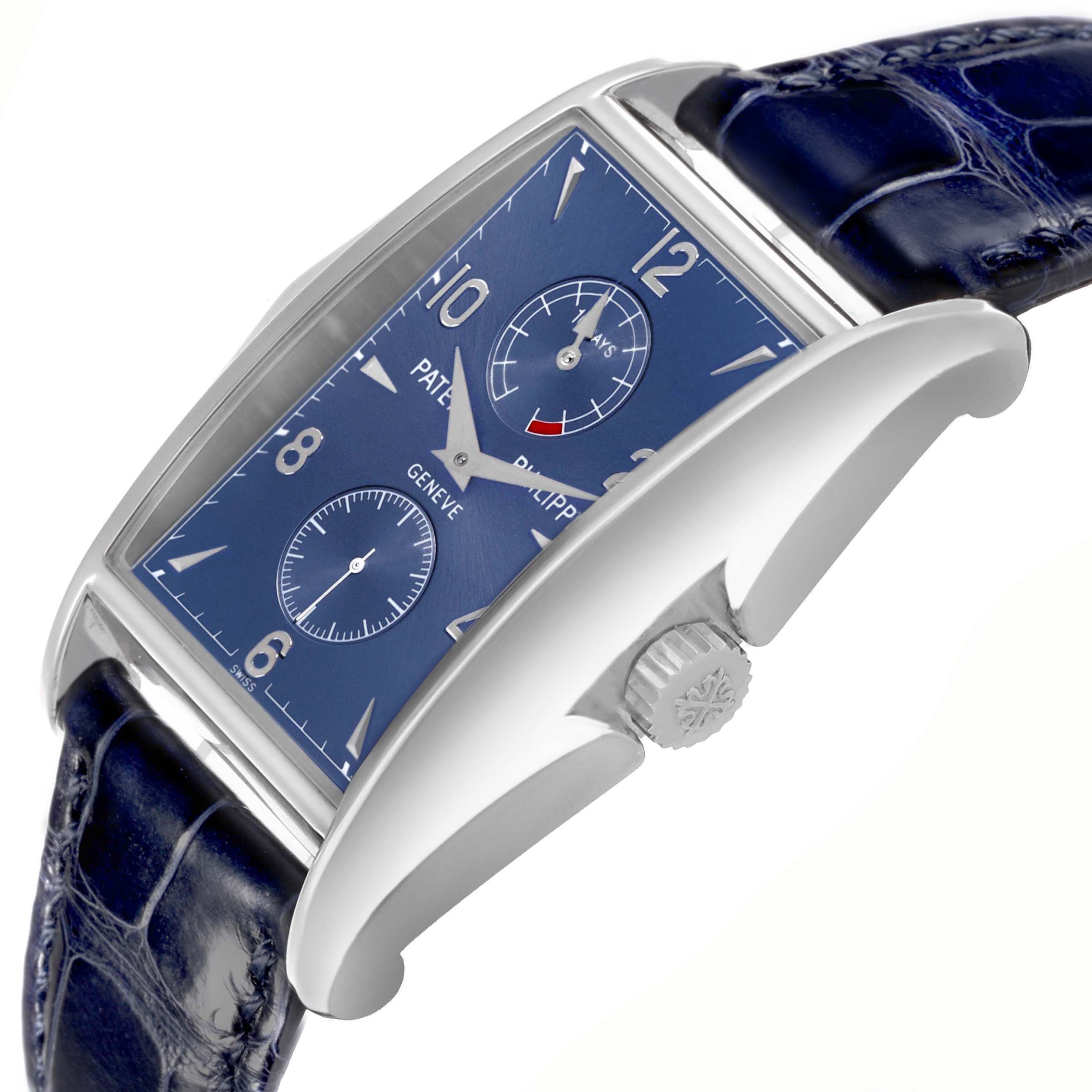 The Patek Philippe Gondolo 5100G - 001 Men's White Gold Blue Dial watch is shown at a dynamic angle, highlighting the blue dial, side profile, and crown.