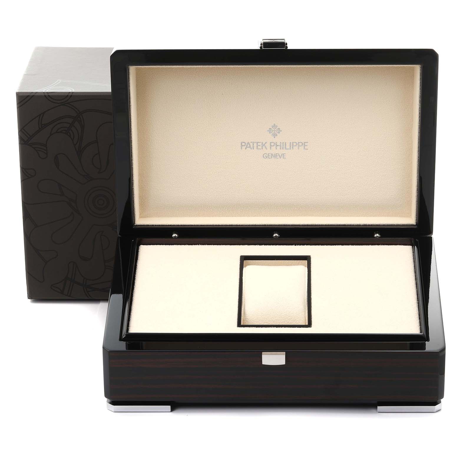 The image shows an open Patek Philippe Gondolo 5100G - 001 Men's White Gold Blue Dial 5100G - 001 Men's White Gold Blue Dial watch box from a front angle, featuring its interior compartments.