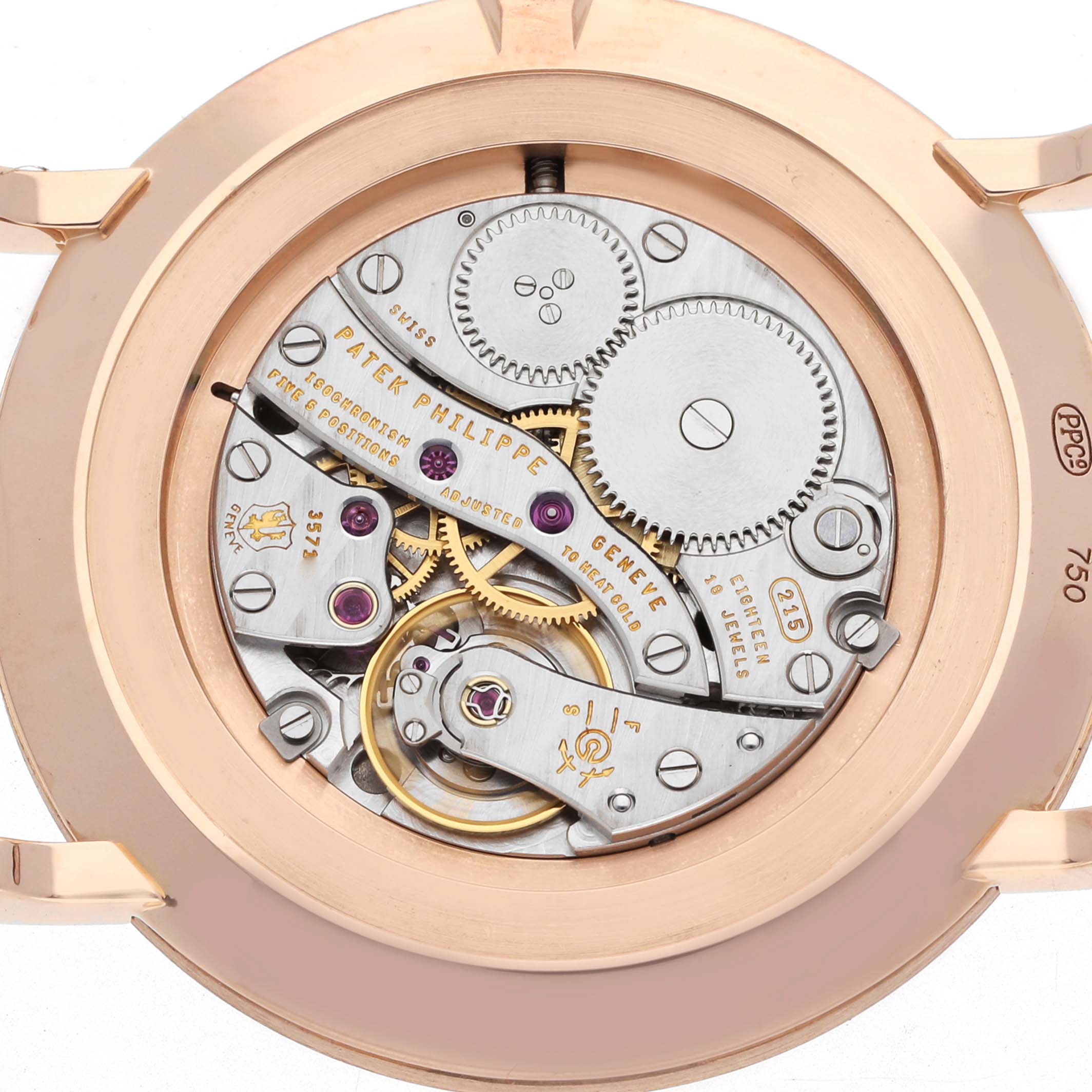 The image shows the movement of a Patek Philippe Calatrava 5119 Men
s Rose Gold White Dial watch from the back, highlighting its gears and intricate components.