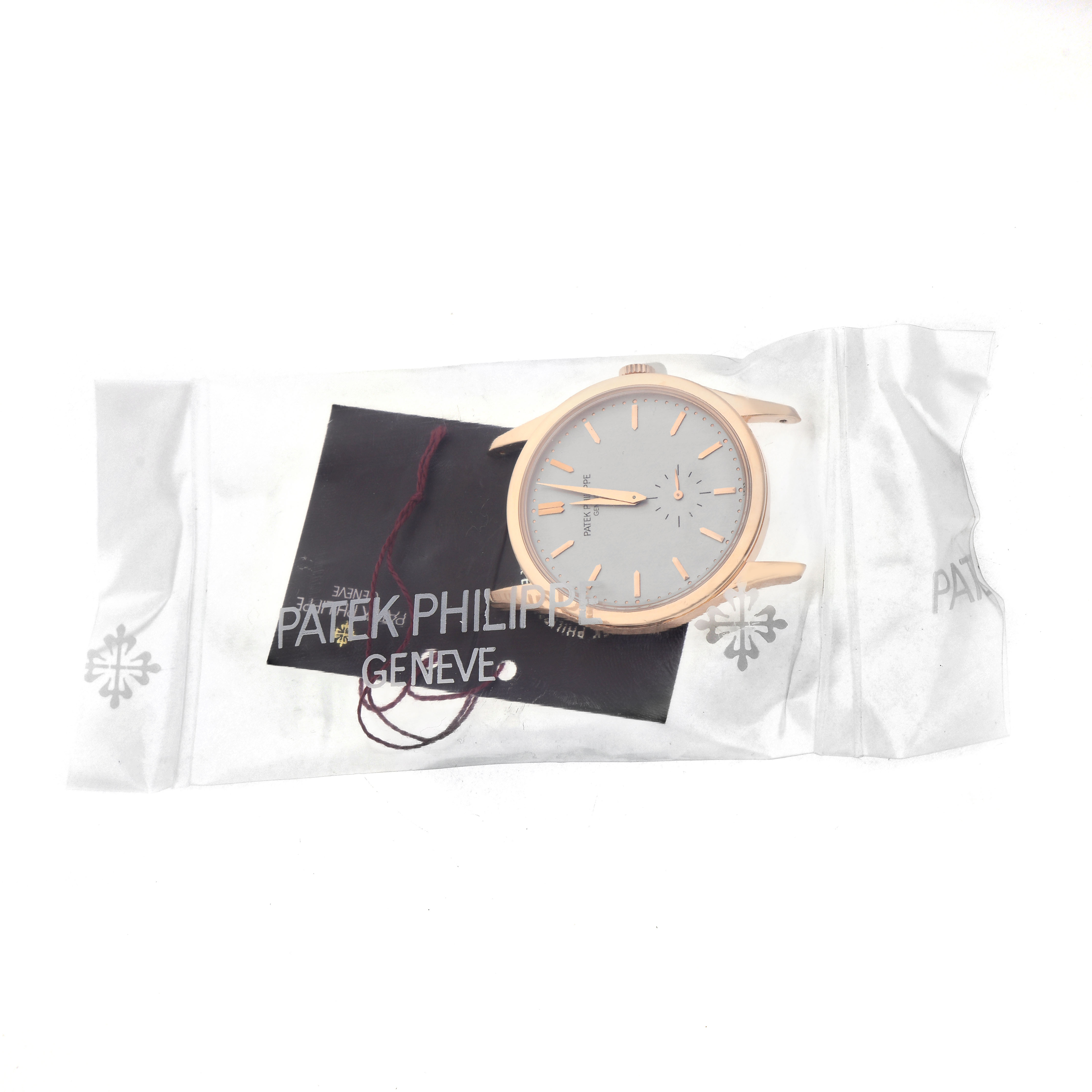 The Patek Philippe Calatrava 5196R-001 Men's Rose Gold Silver Dial watch is shown from the front in a clear plastic packaging without straps.