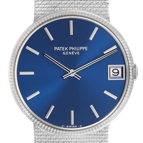 The Patek Philippe Calatrava watch is shown from the front, highlighting its blue dial, hands, indices, and date window.