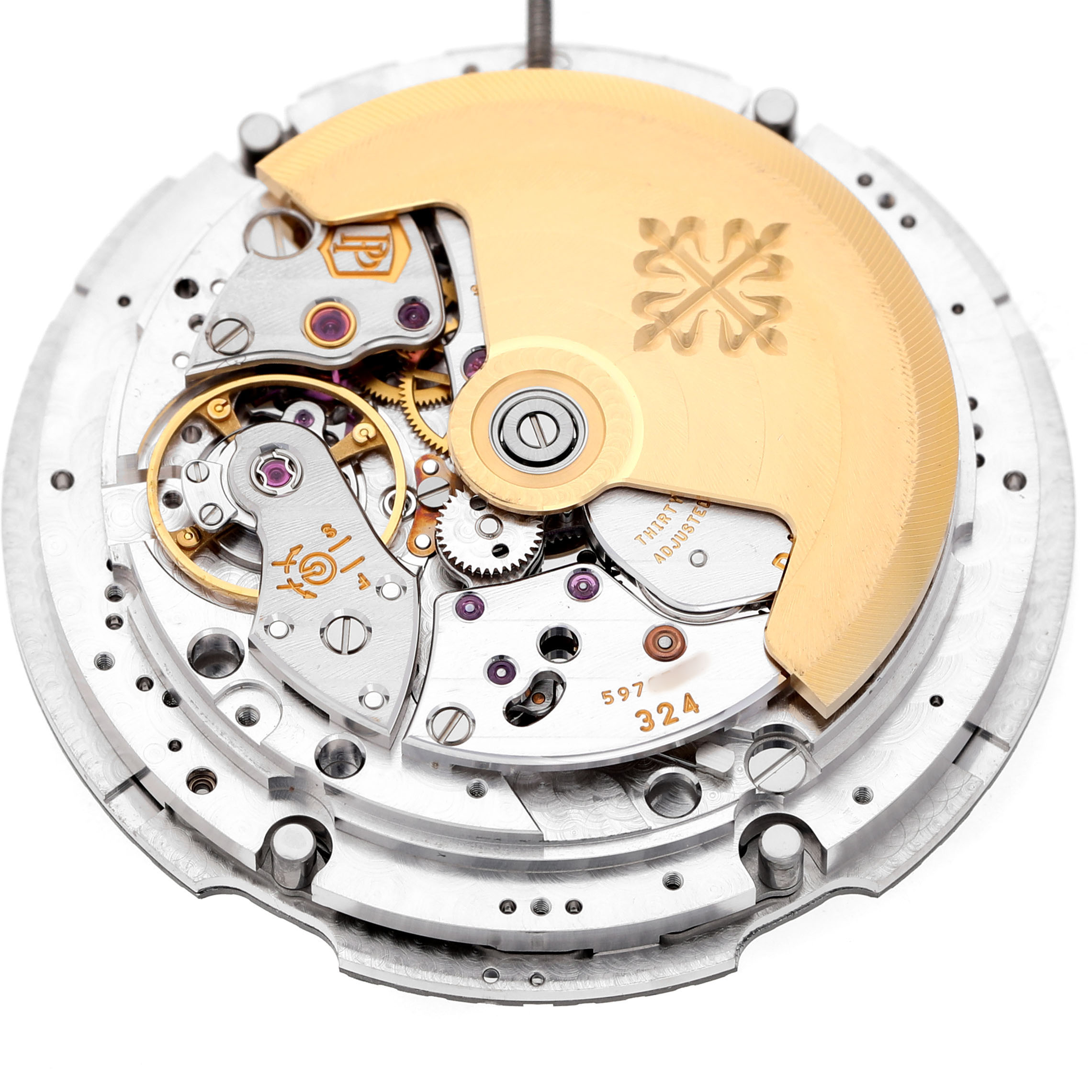 The image shows the movement of a Patek Philippe Nautilus 5726/1A-001 Men's Stainless Steel Green Dial watch, featuring its intricate gears and a gold rotor.