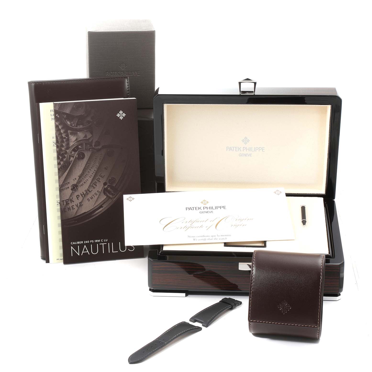 The image shows a Patek Philippe Nautilus 5712G/001 Men's White Gold Grey Dial 5712G/001 Men's White Gold Grey Dial watch set, including the box, documents, straps, and a leather pouch, viewed from the front.