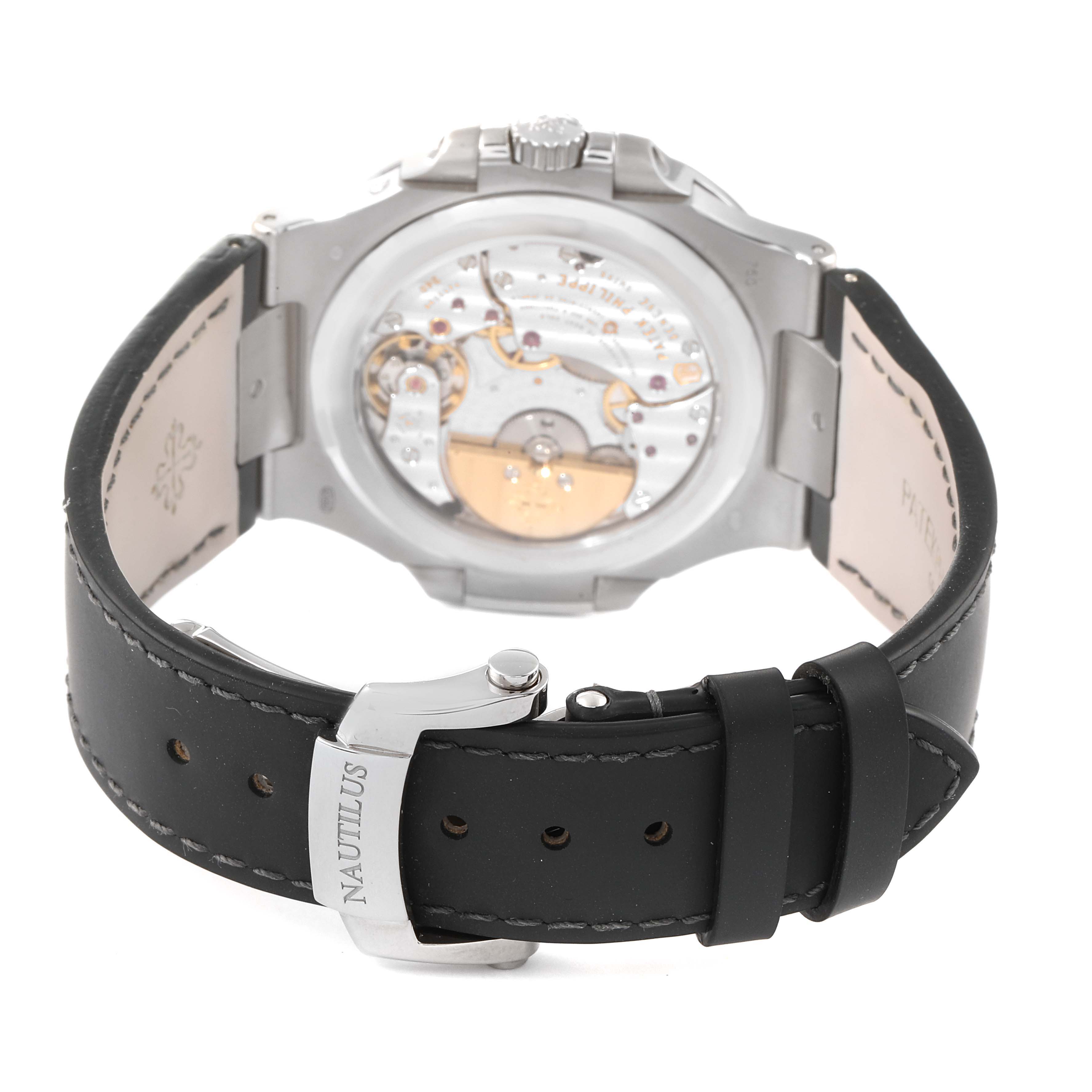 The image shows the back, internal mechanism, and leather strap of a Patek Philippe Nautilus 5712G/001 Men's White Gold Grey Dial 5712G/001 Men's White Gold Grey Dial watch.