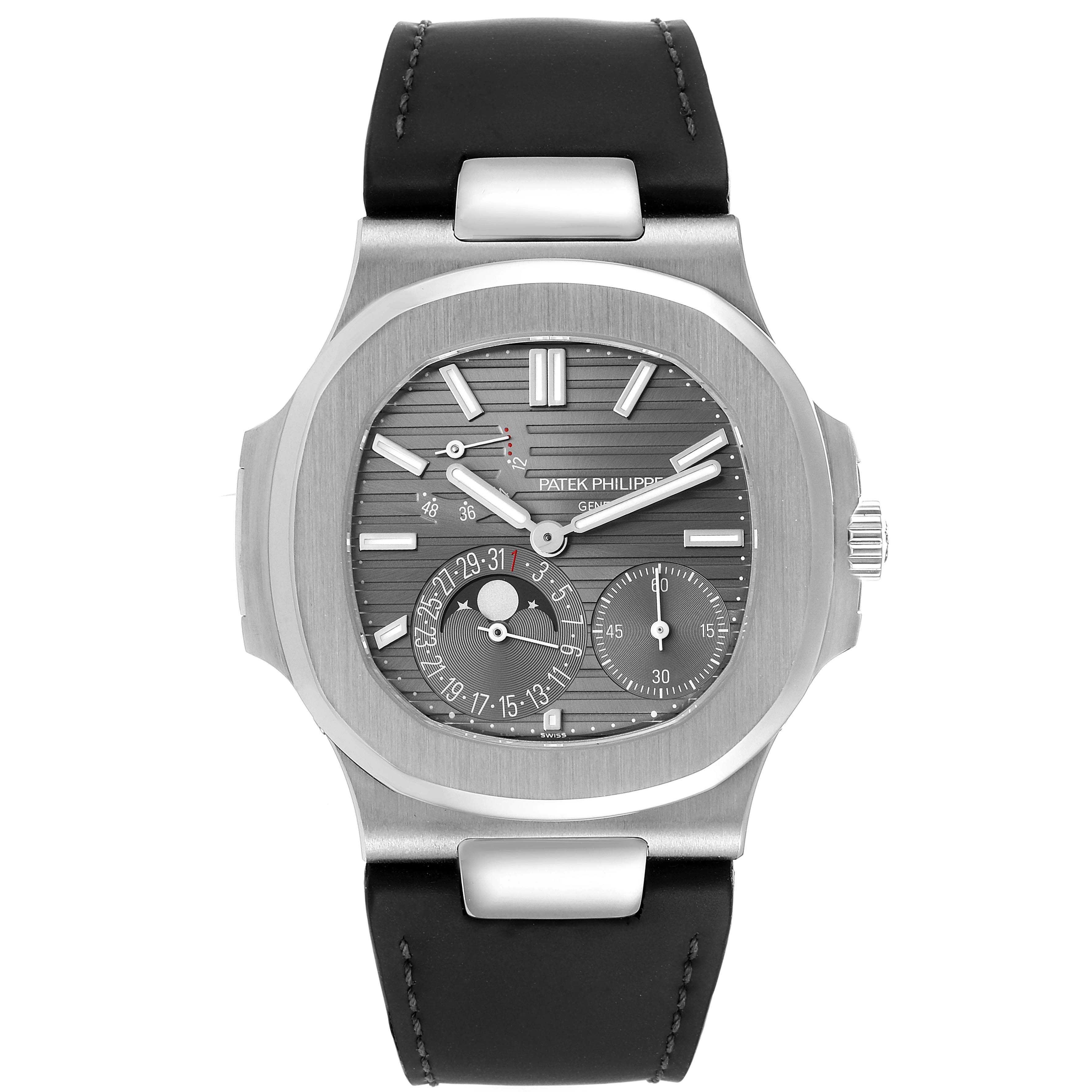 This image shows a Patek Philippe Nautilus 5712G/001 Men's White Gold Grey Dial 5712G/001 Men's White Gold Grey Dial watch from a front view, highlighting the dial, subdials, and black strap.