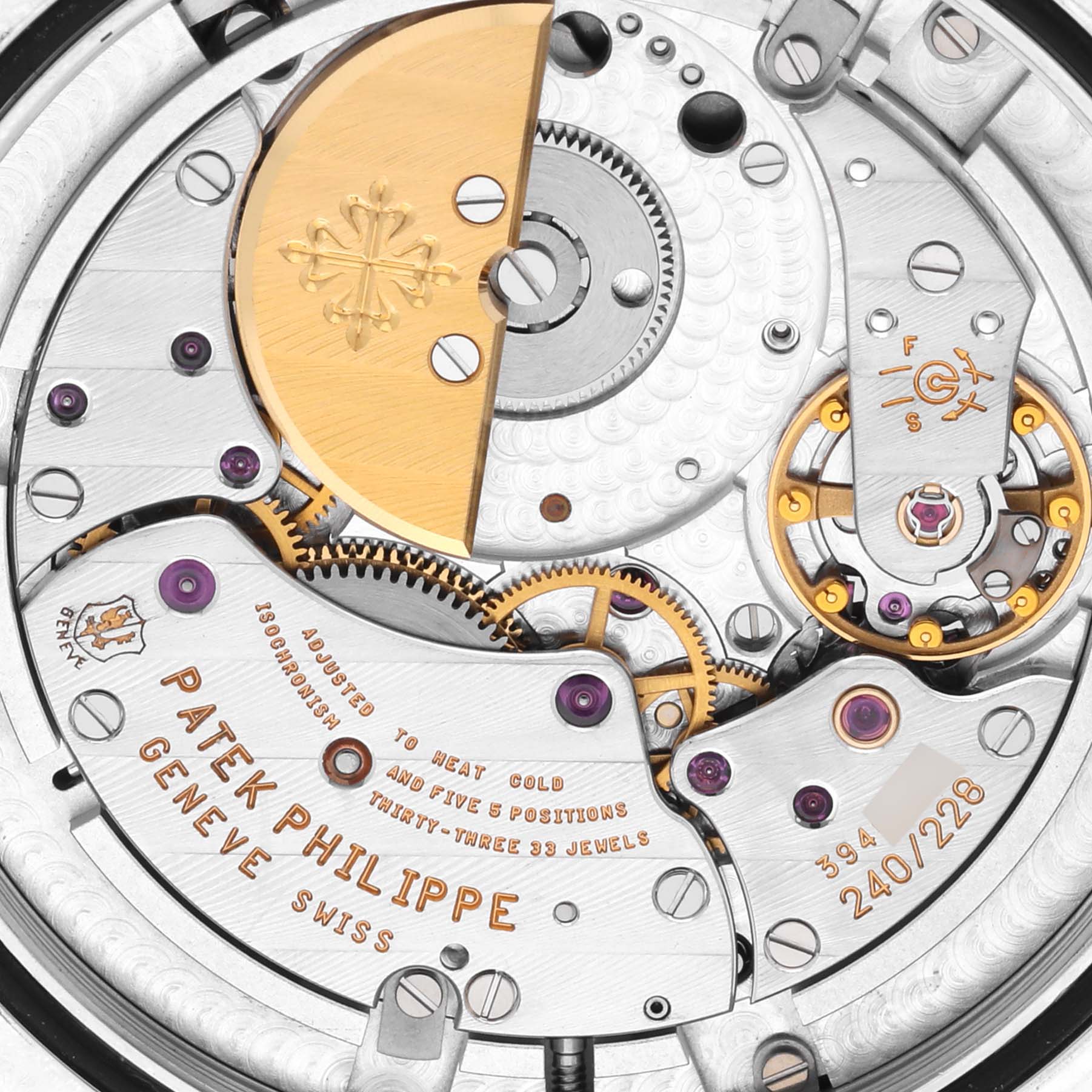 The image shows a close-up of the movement and intricate parts inside a Patek Philippe Complications 5130P-001 Men's Platinum Blue Dial 5130P-001 Men's Platinum Blue Dial watch.
