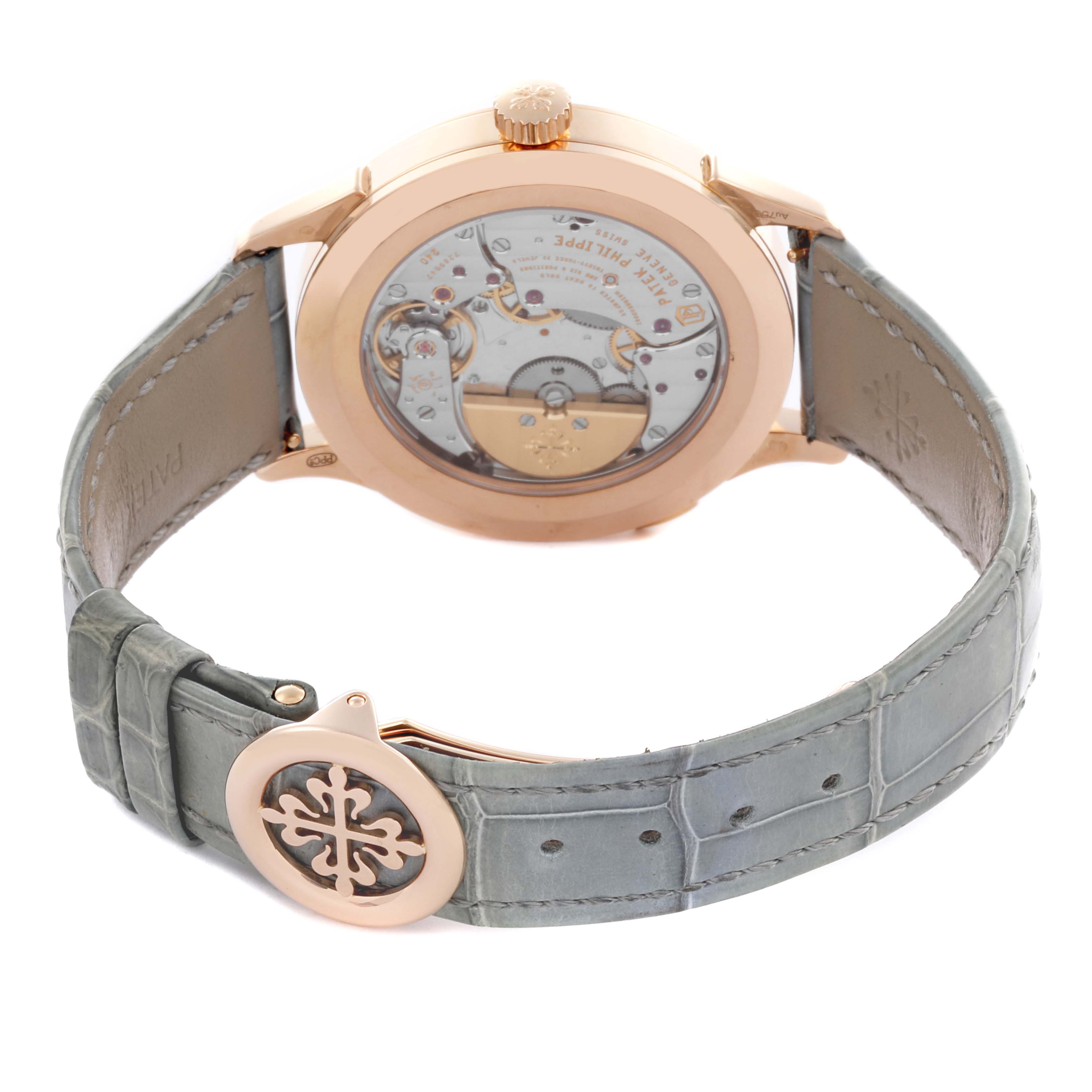 The Patek Philippe Complications 5230R-012 Men's Rose Gold Grey Dial 5230R-012 Men's Rose Gold Grey Dial watch is shown from the back, highlighting the movement and leather strap with buckle.