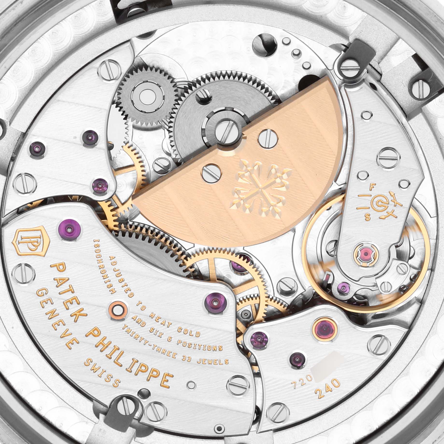 The image shows a close-up of the movement of a Patek Philippe Complications 5230G-001 Men's White Gold Grey Dial 5230G-001 Men's White Gold Grey Dial watch, featuring gears and engravings.