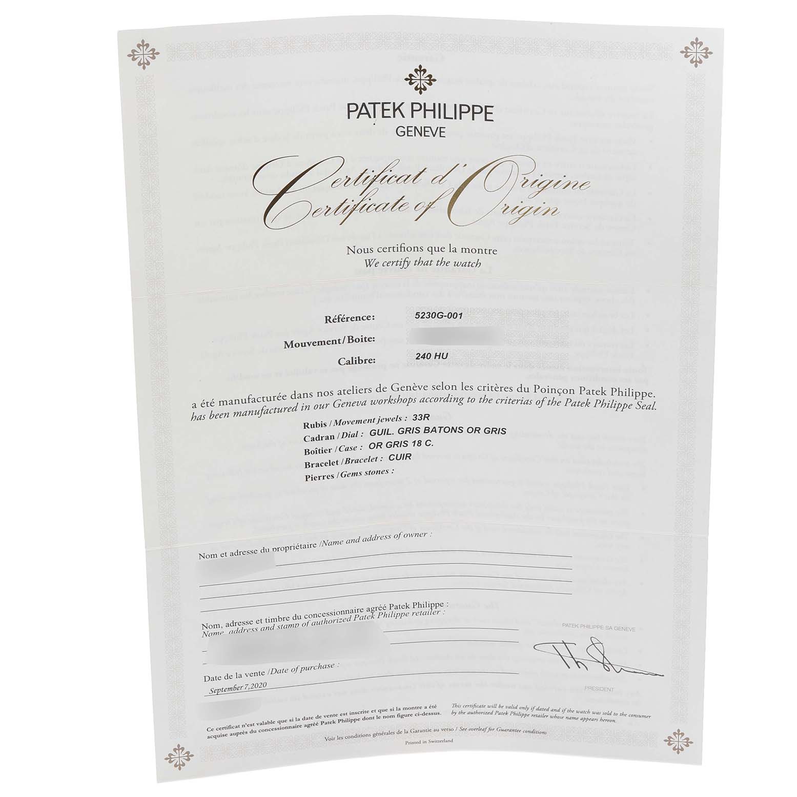 The image shows a "Patek Philippe Complications 5230G-001 Men's White Gold Grey Dial 5230G-001 Men's White Gold Grey Dial" Certificate of Origin document at an angled view.