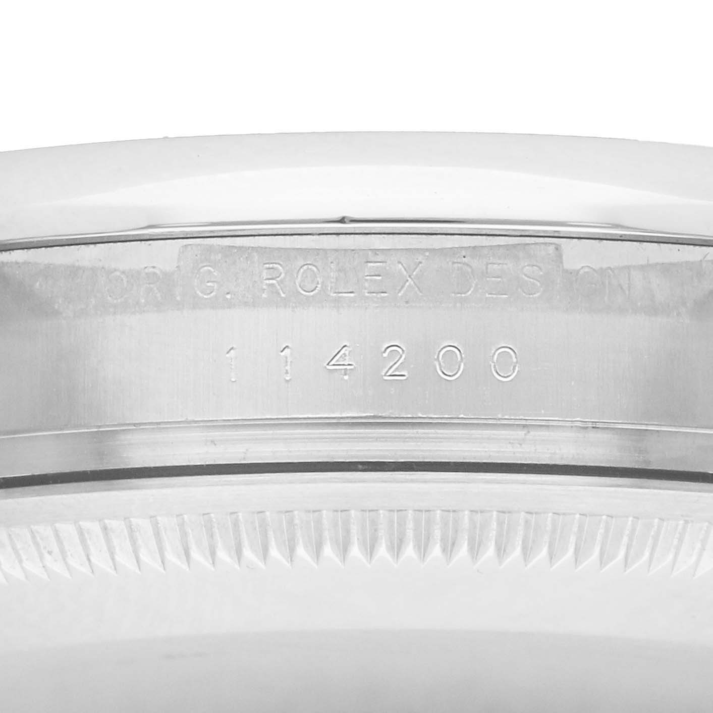 The image displays the reference number engraved on the side of the Rolex Air-King 114200 Men
s Stainless Steel Blue Dial case.