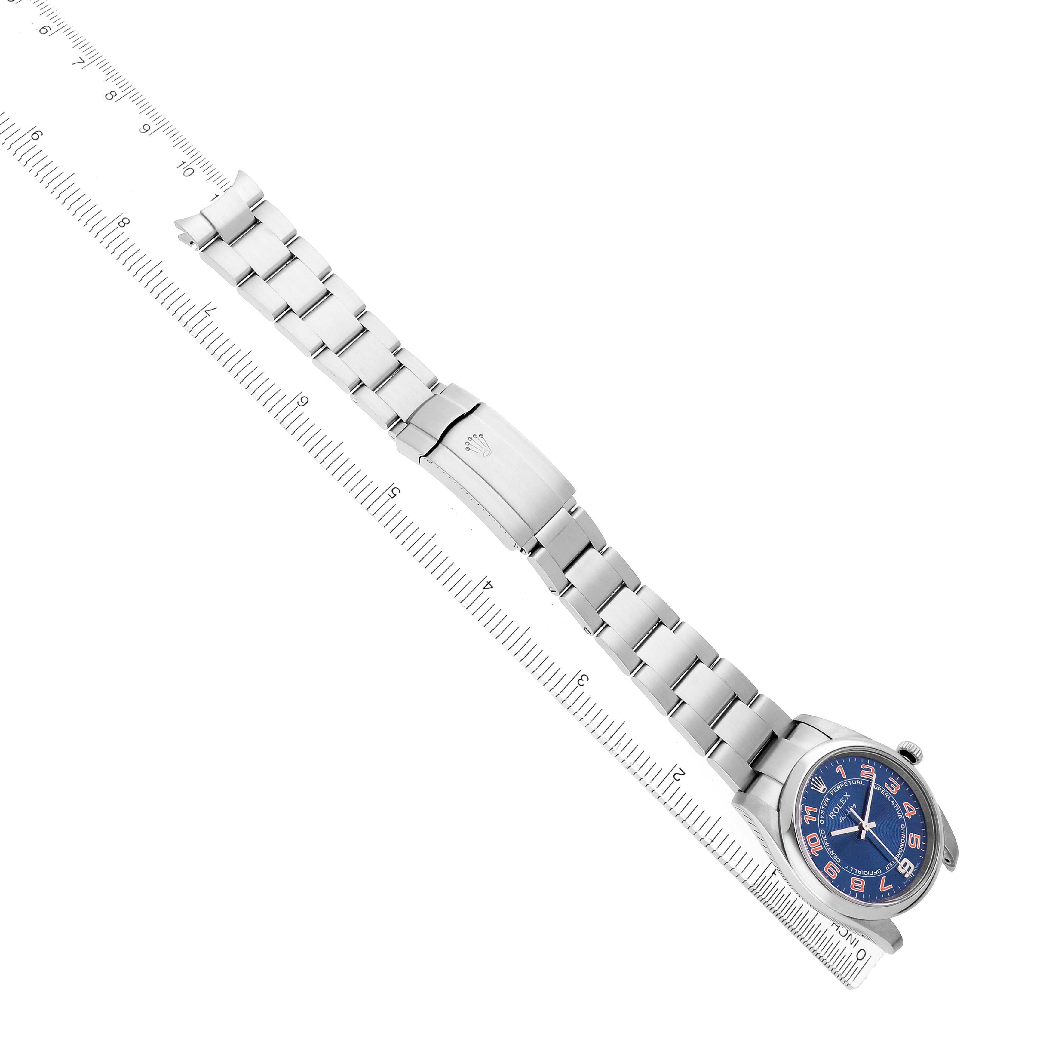 The Rolex Air-King 114200 Men
s Stainless Steel Blue Dial watch is shown diagonally from the top, highlighting the bracelet, clasp, and blue dial with a measuring scale.