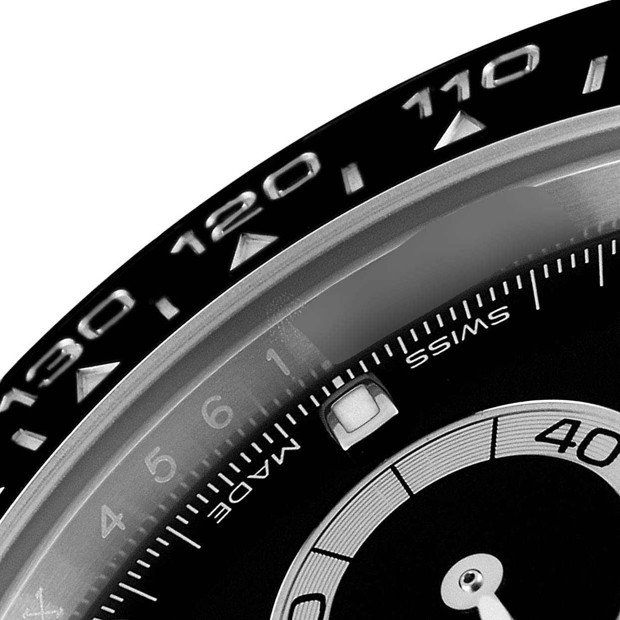 The image shows a close-up of the bezel and part of the dial of a Rolex Daytona 116500 Men's Stainless Steel Black Dial 116500 Men's Stainless Steel Black Dial watch, displaying numbers and markings.
