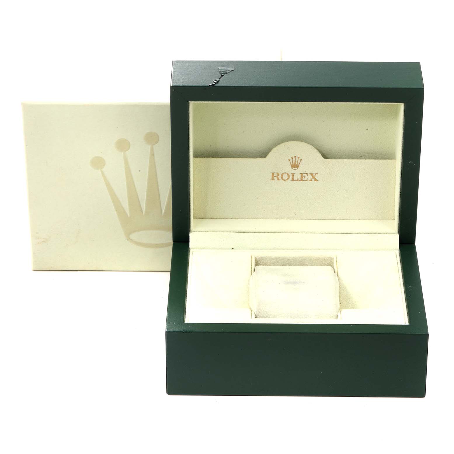 This image shows an open green and beige Rolex watch box for the Date model, with the outer box in the background.