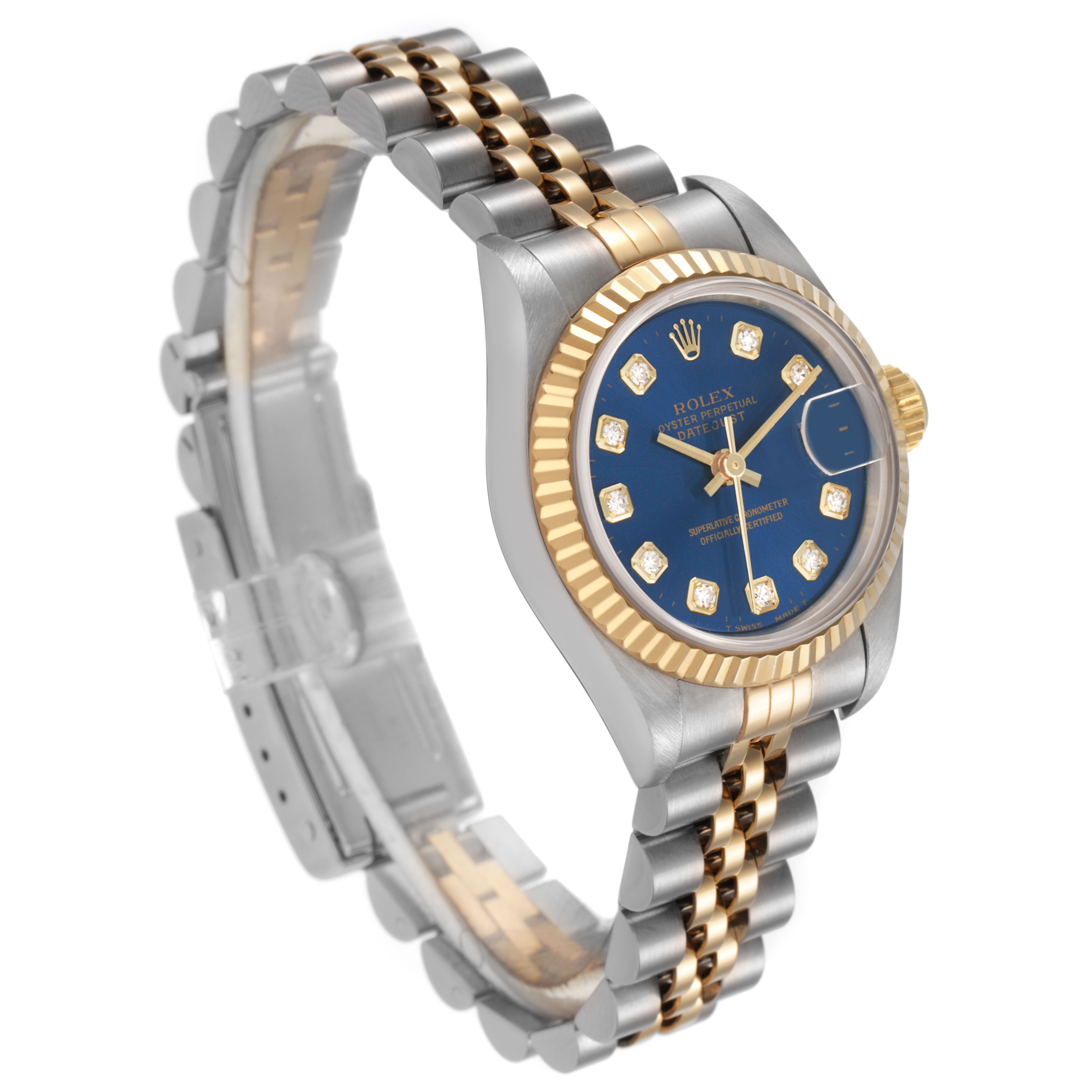 The Rolex Datejust 69173 Women's Steel and Gold (two tone) Blue Dial watch is shown from a side angle, highlighting the case, fluted bezel, Jubilee bracelet, and blue dial.
