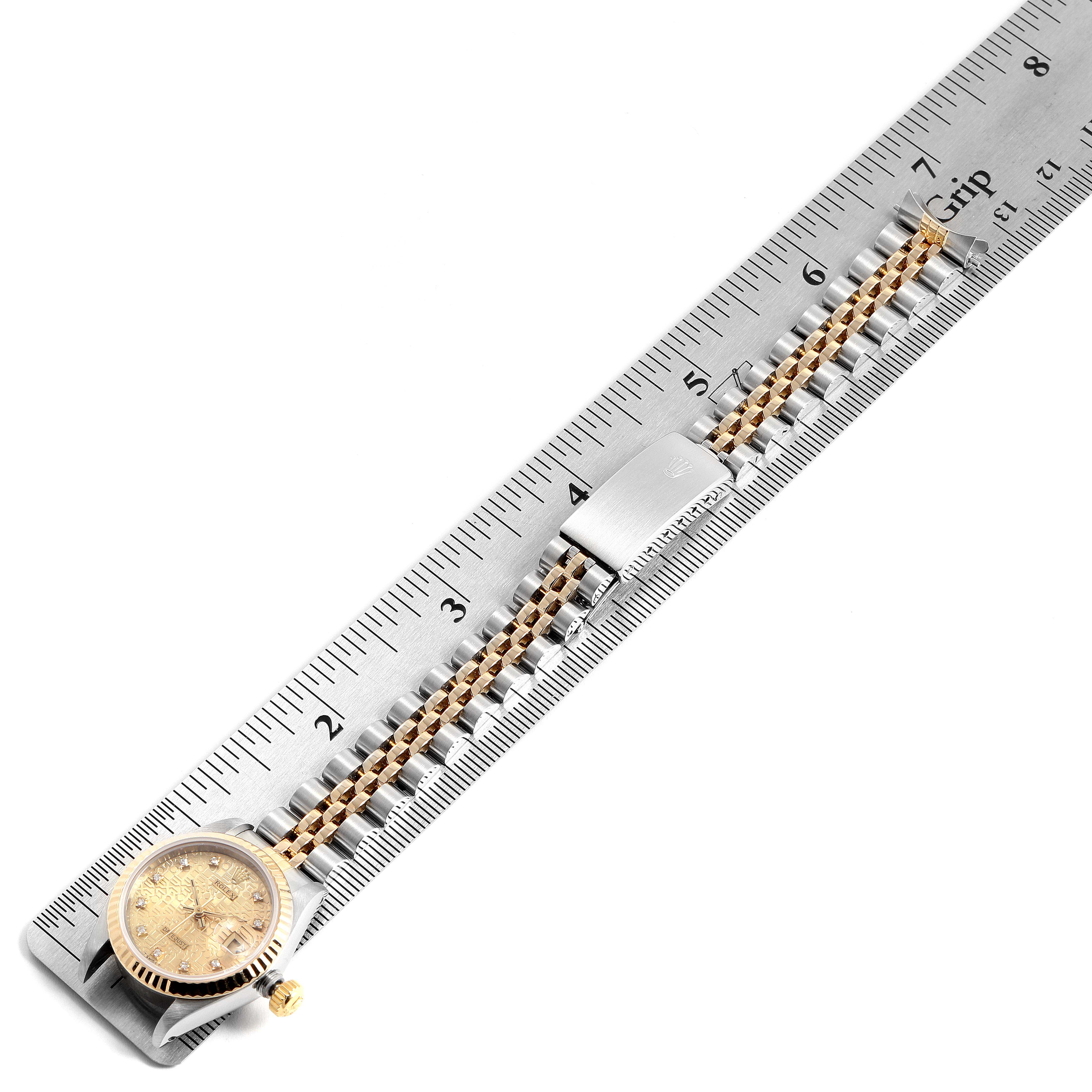 The Rolex Datejust 69173 Women's Steel and Gold (two tone) Champagne Dial 69173 Women's Steel and Gold (two tone) Champagne Dial watch is shown from a top-down angle, displaying its face and band beside a ruler for measurement.