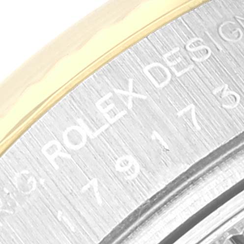 The image shows a close-up angle of the Rolex Datejust 179173 Women's Steel and Gold (two tone) Silver Dial 179173 Women's Steel and Gold (two tone) Silver Dial model, focusing on the engraved markings on the watch case back.