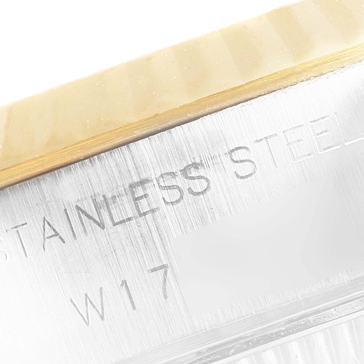 This image shows a close-up of the side casing with "STAINLESS STEEL" engraved on a Rolex Datejust 69173 Women's Steel and Gold (two tone) Champagne Dial 69173 Women's Steel and Gold (two tone) Champagne Dial watch.